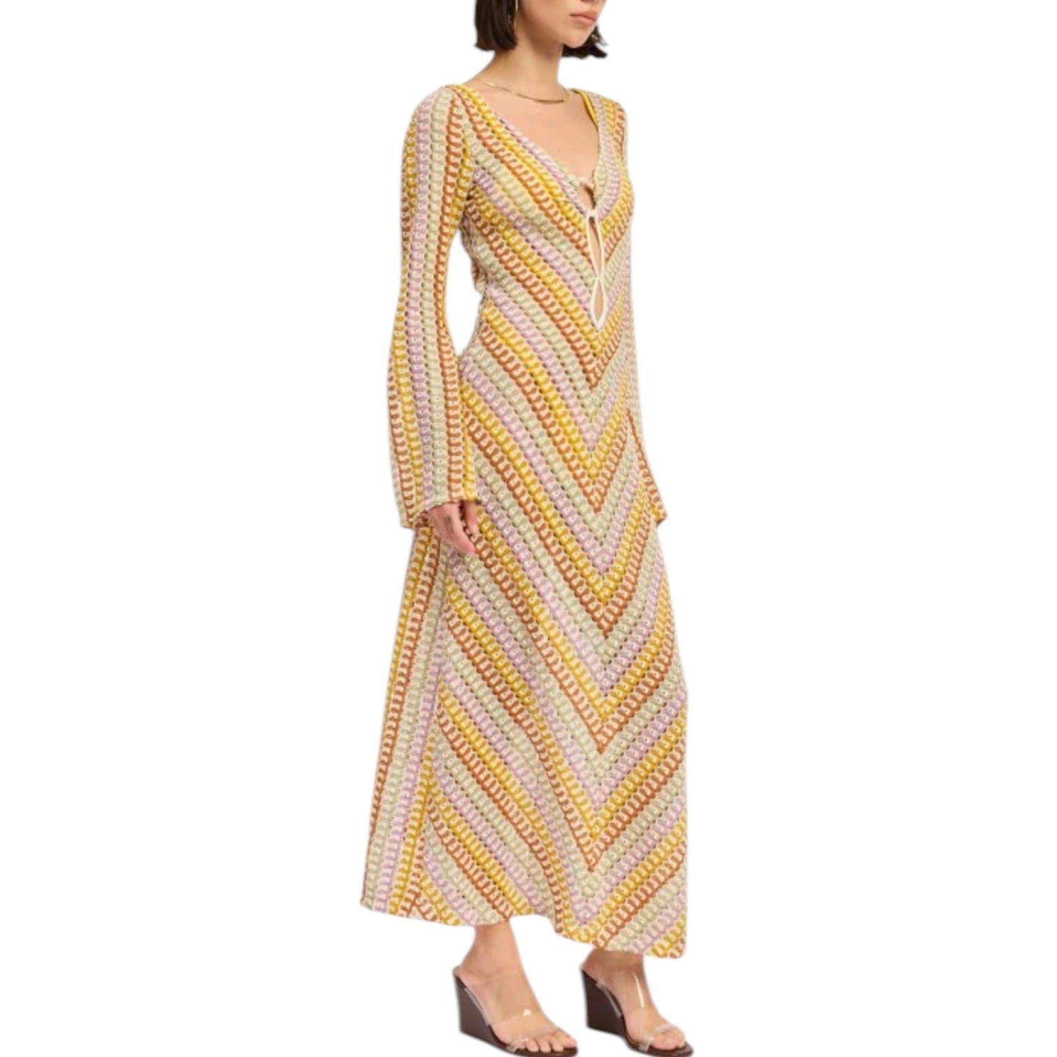 Woman wearing a long, patterned dress on a white background