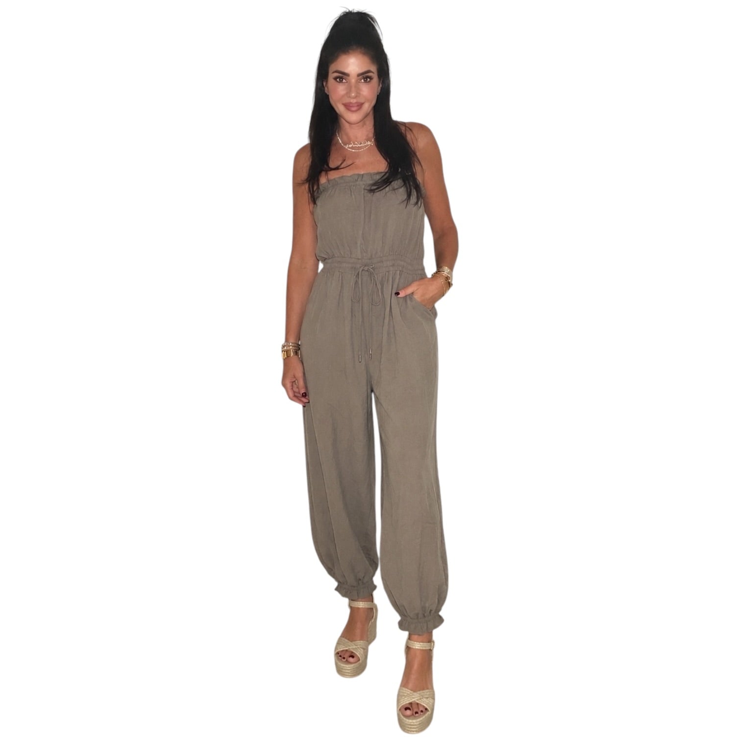 woman wearing taupe jumpsuit on white background