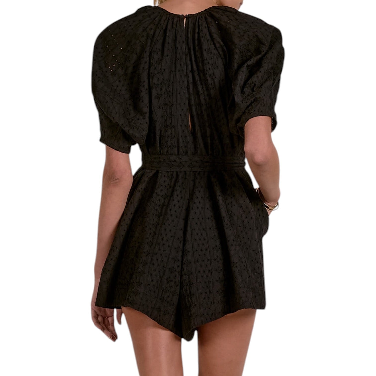 Black patterned romper on a white background