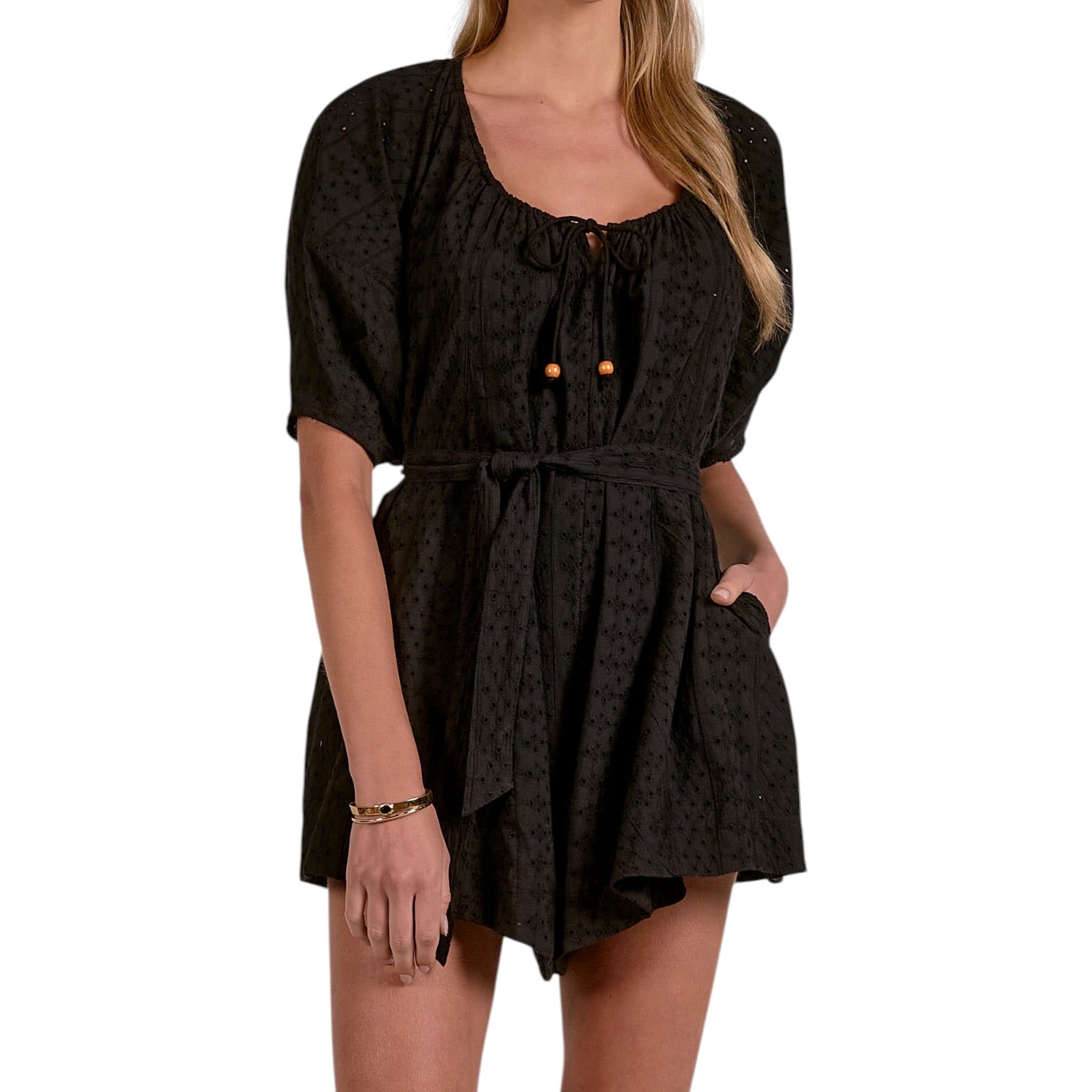 Woman wearing a black patterned dress on a white background