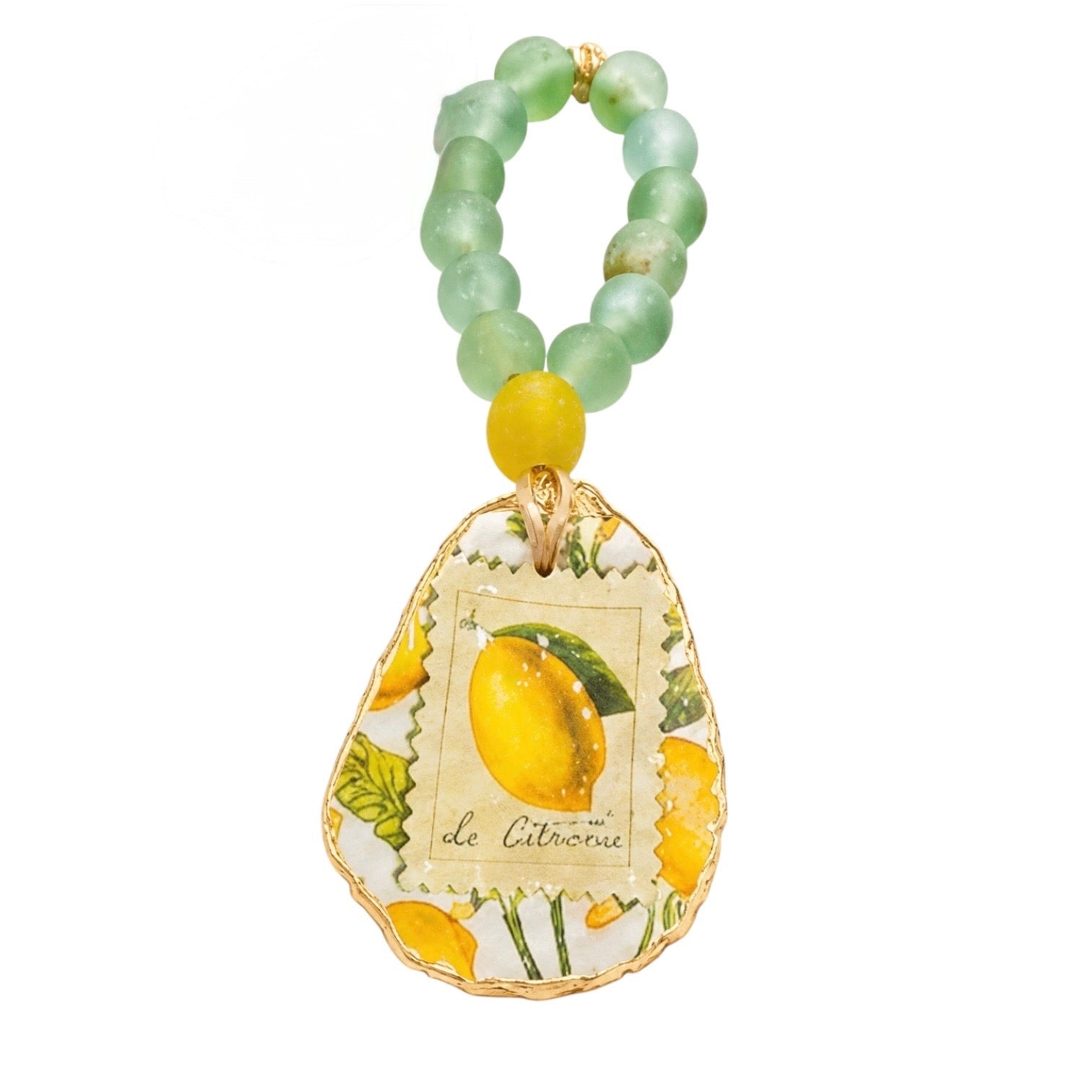 A beaded keychain or bag charm featuring light green translucent beads, a single yellow bead, and a decorative teardrop-shaped pendant with a lemon illustration and the words 'de Citrou' on a white background.