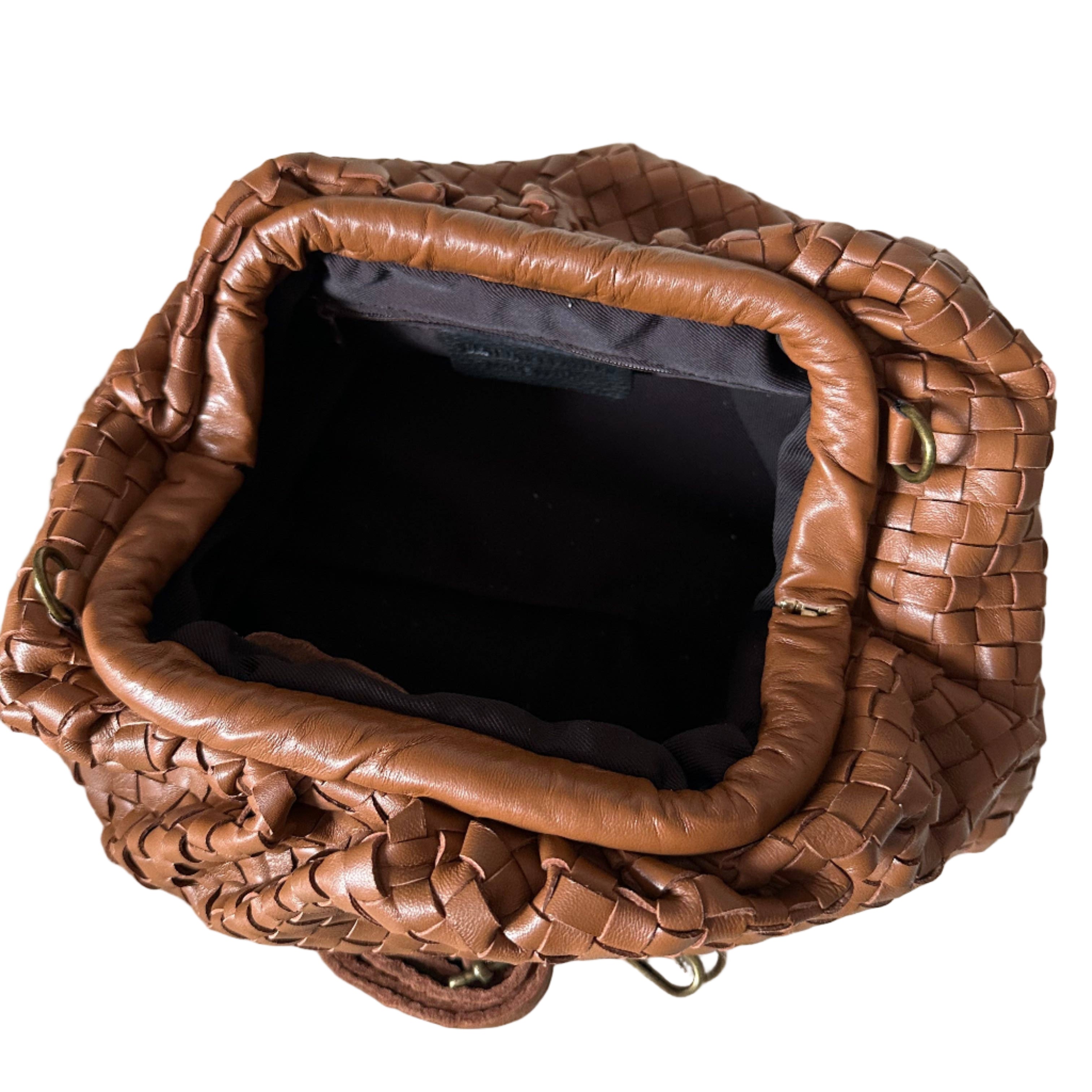 Cognac woven handbag on a white background