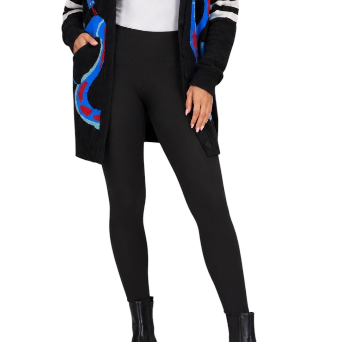 A model wearing black leggings, a white top, and a black cardigan with colorful blue, red, and white abstract patterns, shown against a plain white background.