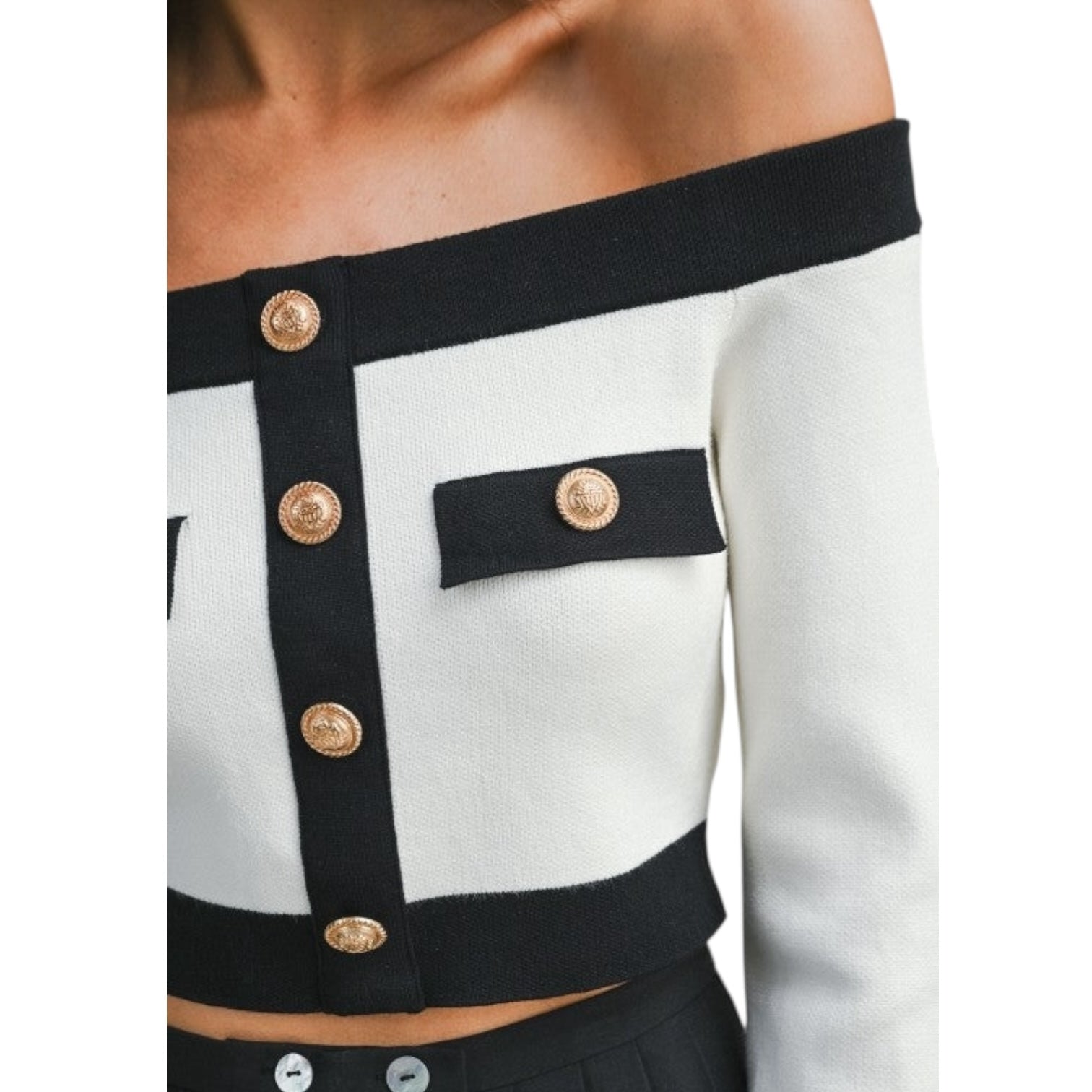 Black and white cardigan with gold buttons on a white background