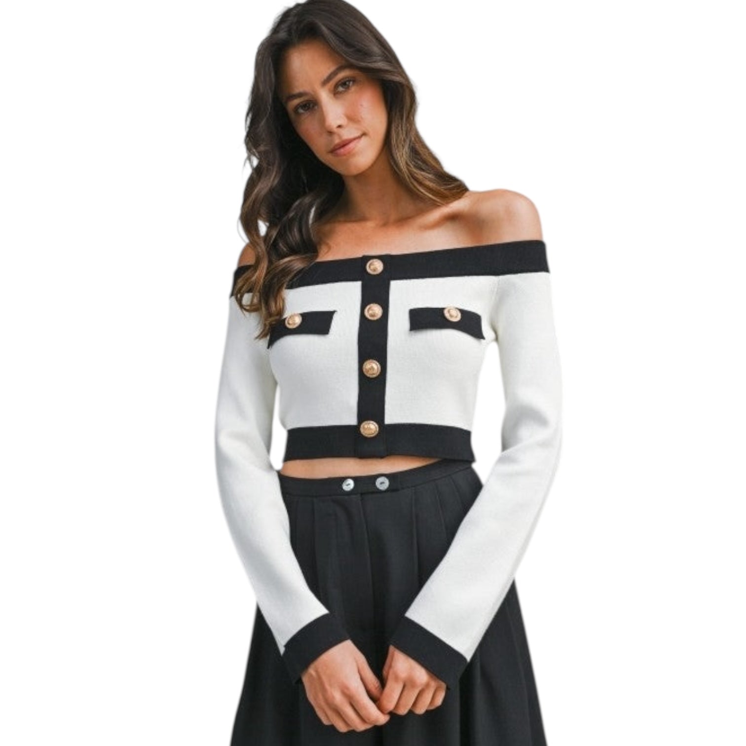 Woman wearing a black and white off-shoulder top with button details on a white background