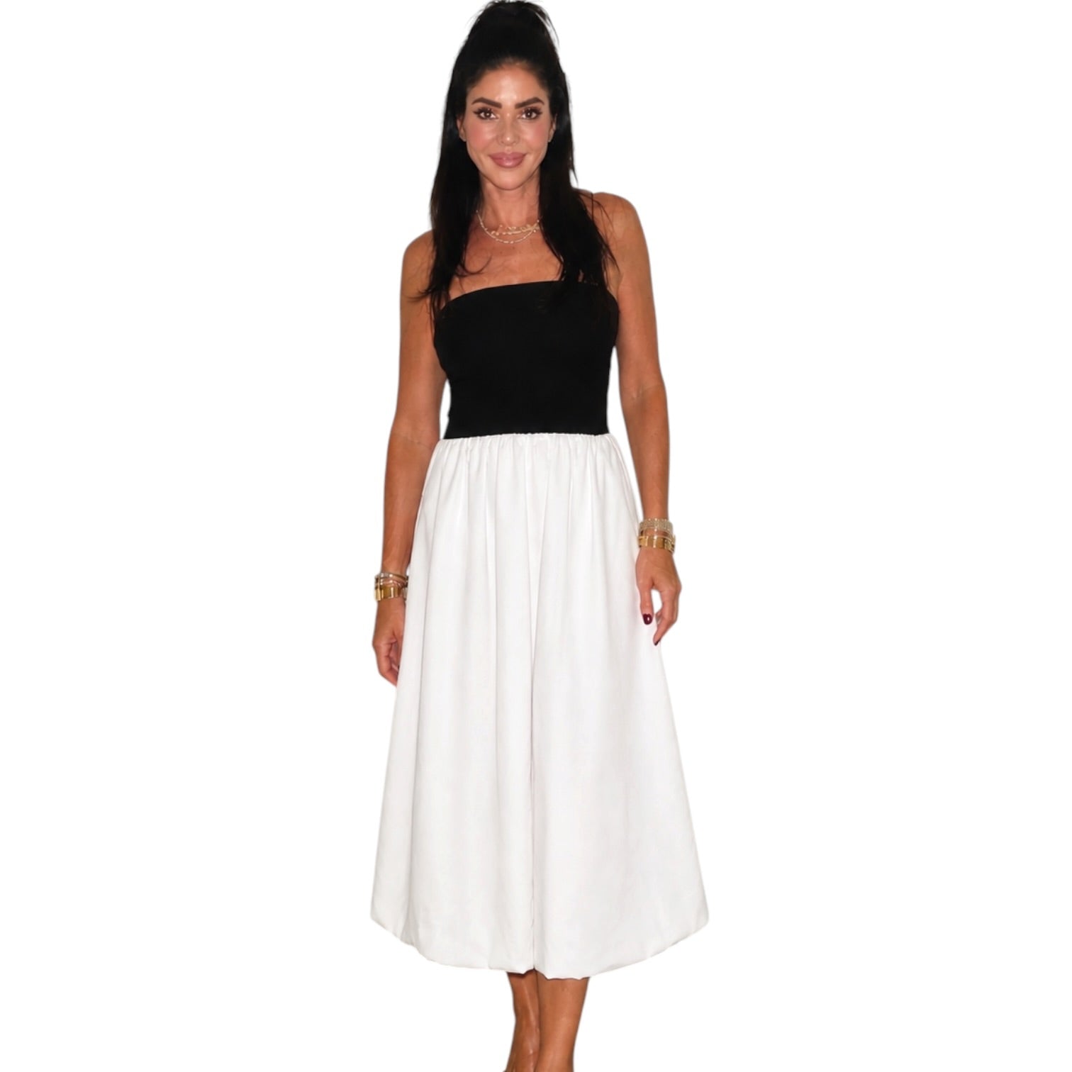 Woman wearing a black and white dress on a white background