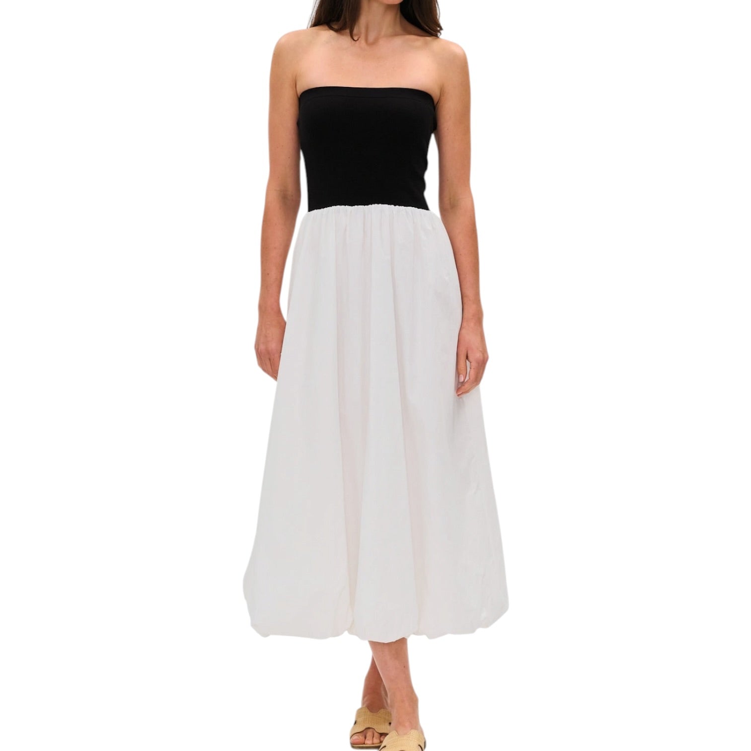 Woman wearing a black strapless dress on a white background