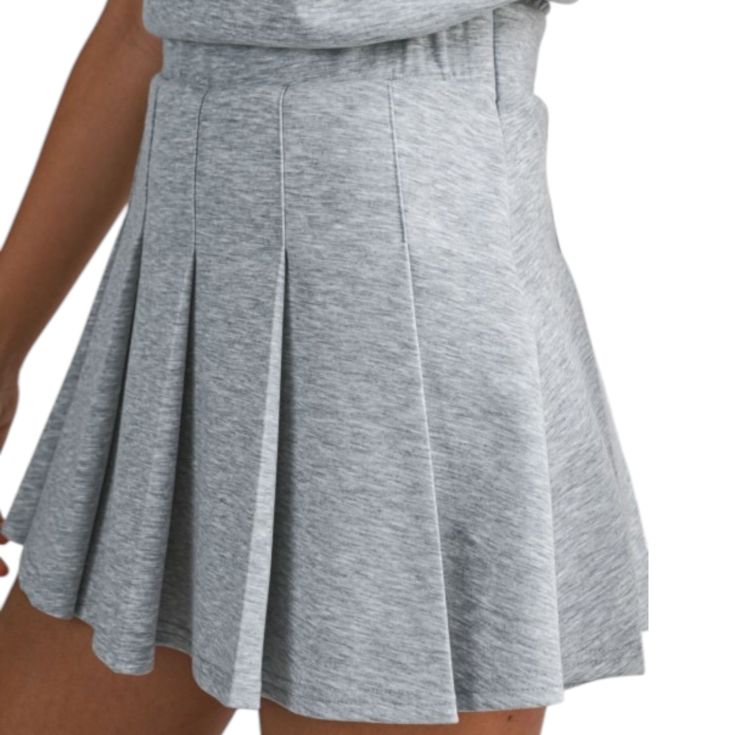 Gray pleated skirt worn by a person on a white background