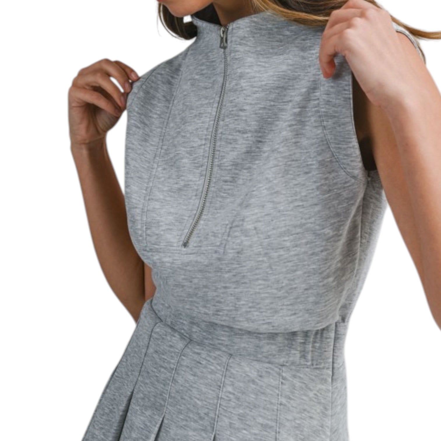 Gray sleeveless top with a quarter zip and matching pants on a white background