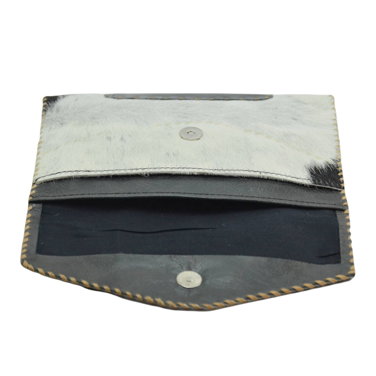 A small leather pouch or wallet shown open on a plain white background. The exterior is made of light gray to off-white hair-on-hide leather with dark black hair showing through, finished with tan whipstitching along the edges.