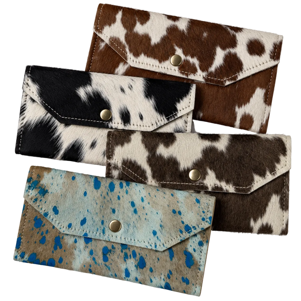 Four wallet-style card holders with flap closures and snap buttons, arranged on a white background. The materials show different animal-print and splatter patterns: brown and cream cowhide, black and cream cowhide, dark brown and cream hair-on-hide, and tan with bright blue paint splatter.