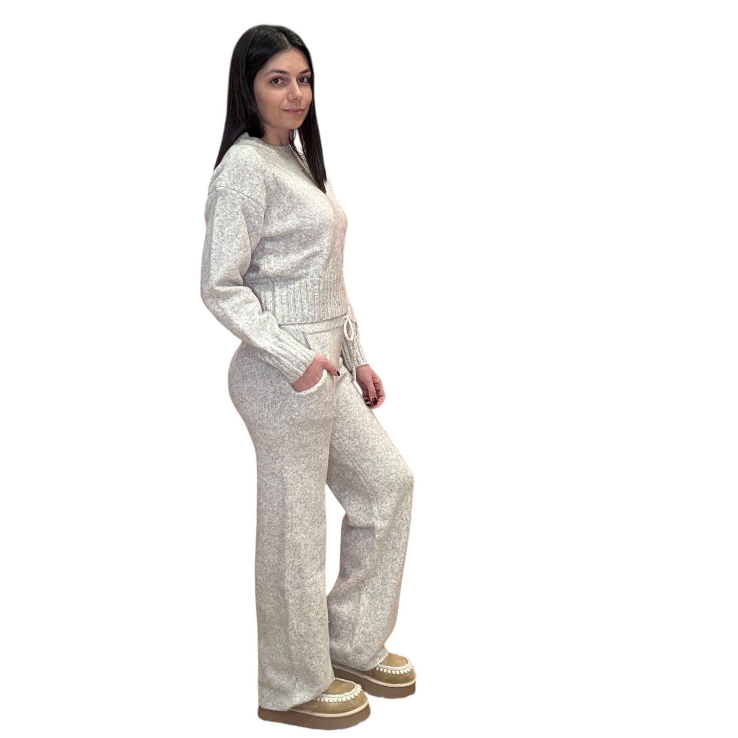 Woman wearing a oat knitted outfit on a white background