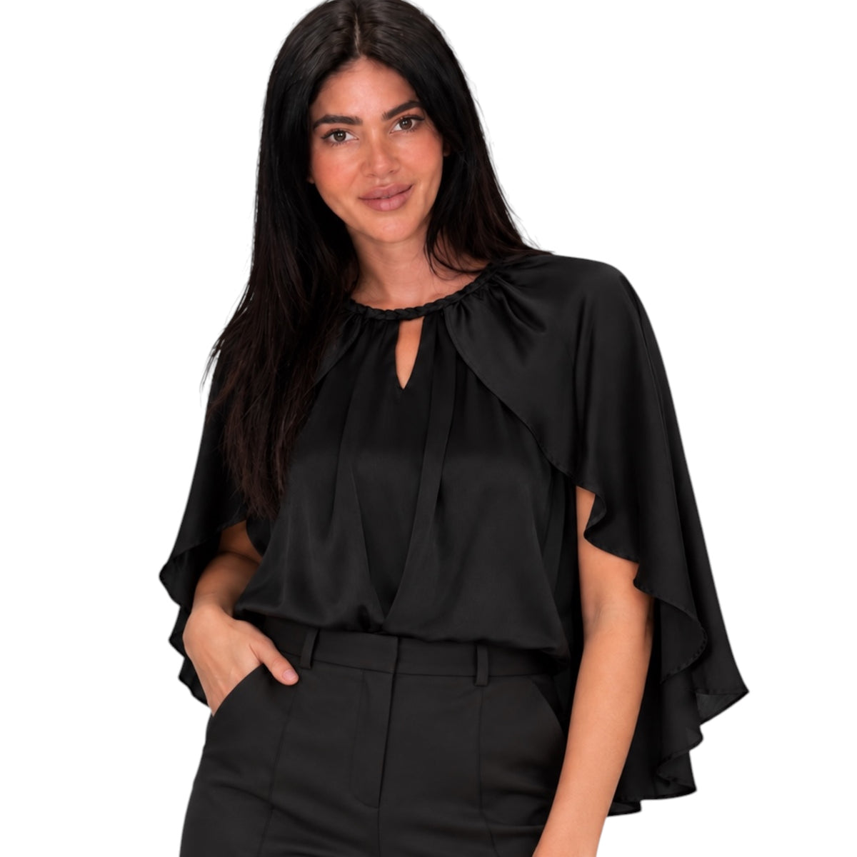 A woman modeling a black satin-like blouse with a keyhole neckline, draped cap sleeves, and a high waist, paired with black trousers against a plain white background.