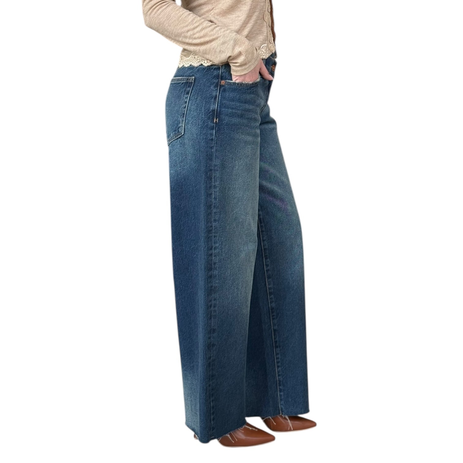 Person wearing blue wide-leg jeans on a white background