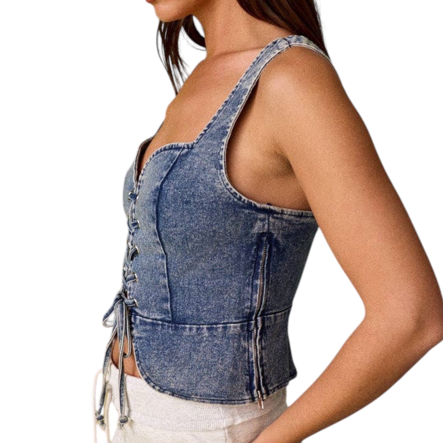 woman wearing denim lace-up corset top on white background