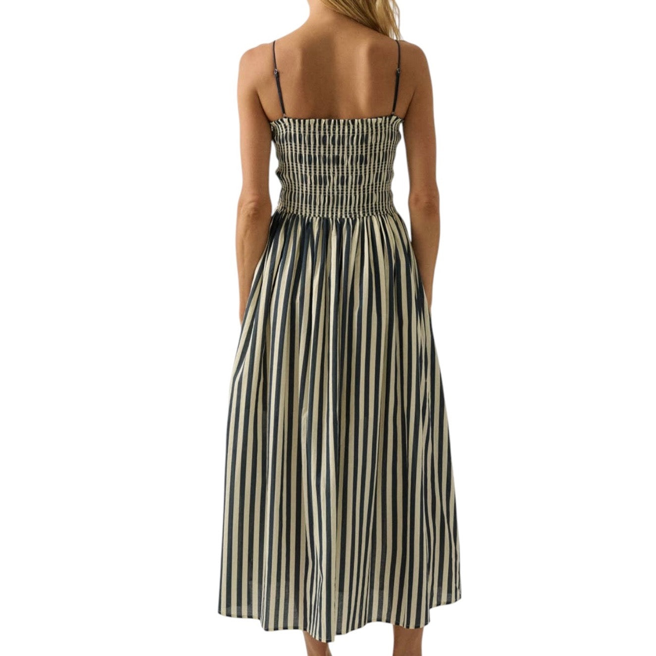 Woman wearing a denim and white striped dress on a white background