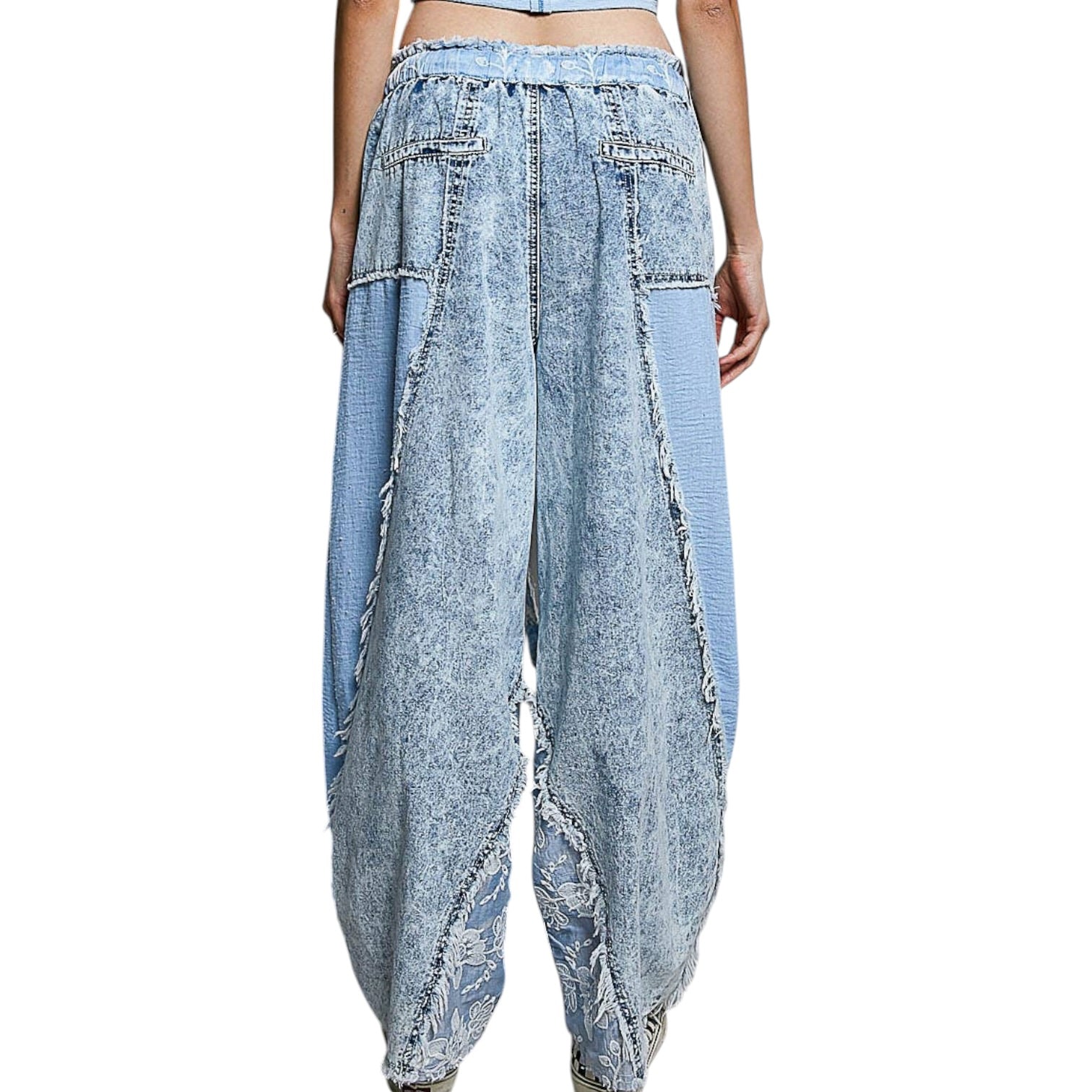 Light blue distressed denim pants on a white background