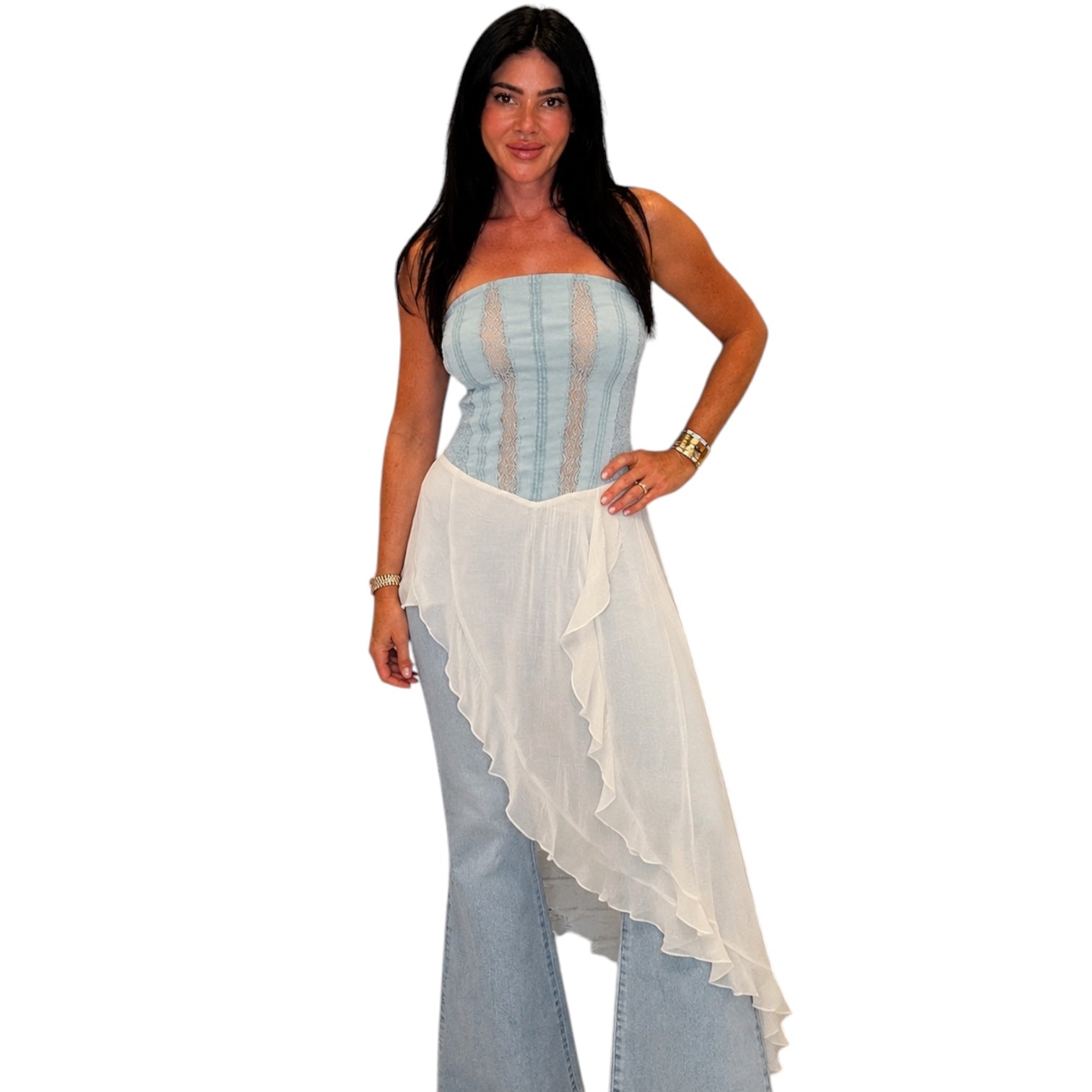 Woman wearing a strapless top and jeans with a white overlay on a white background
