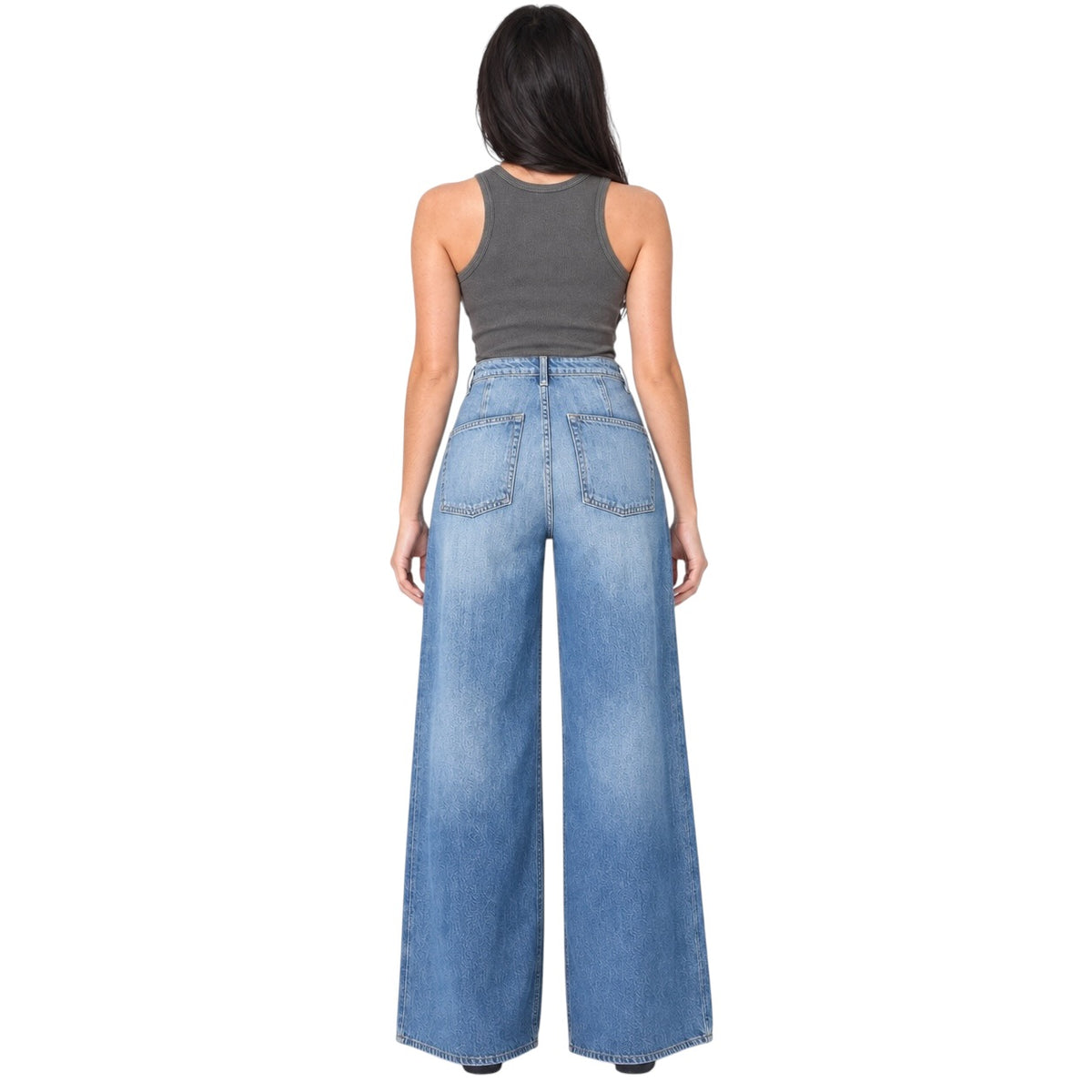A woman shown from the back wearing a dark gray ribbed tank top and high-waisted, wide-leg blue denim jeans with a faded wash.