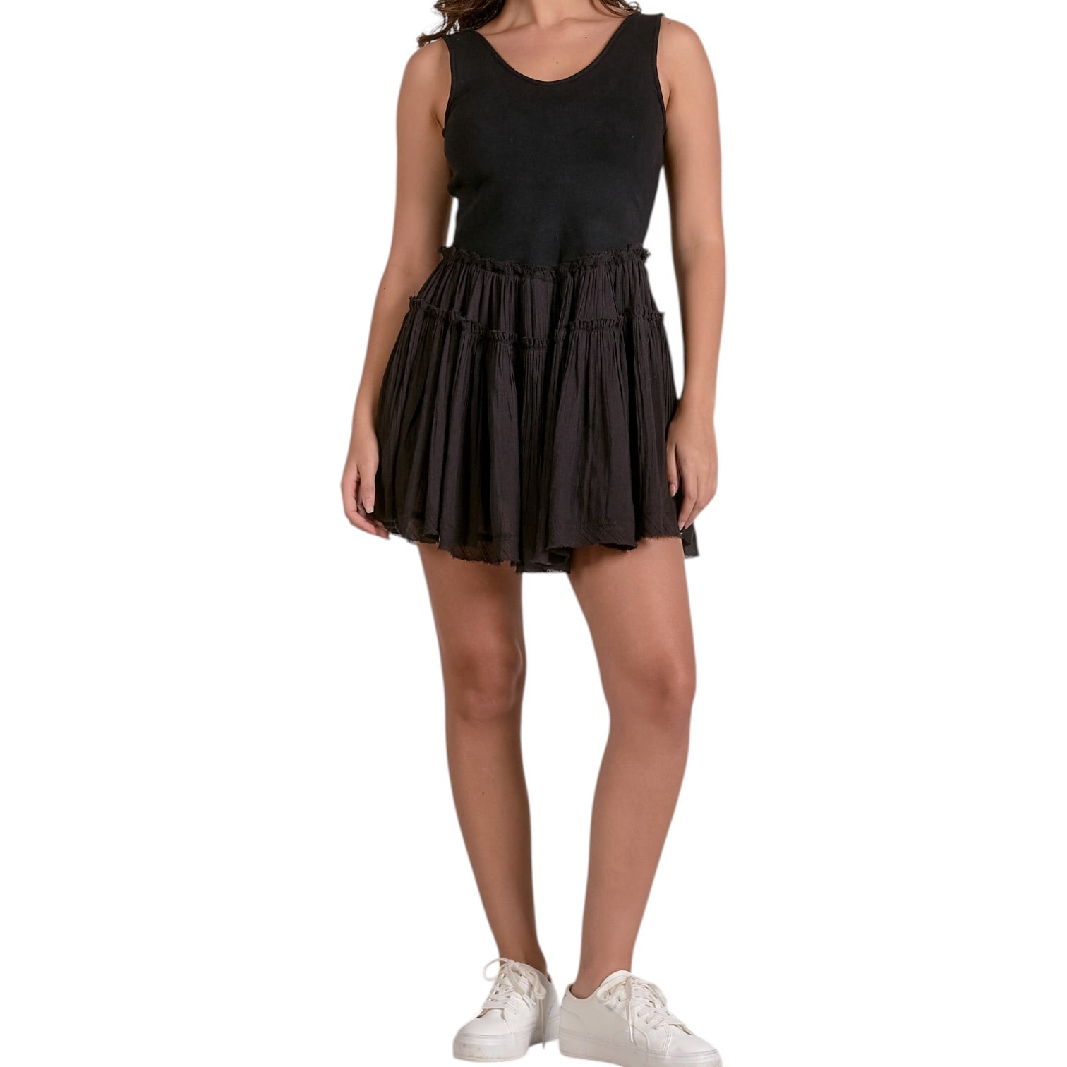 Black tiered dress worn by a person on a white background