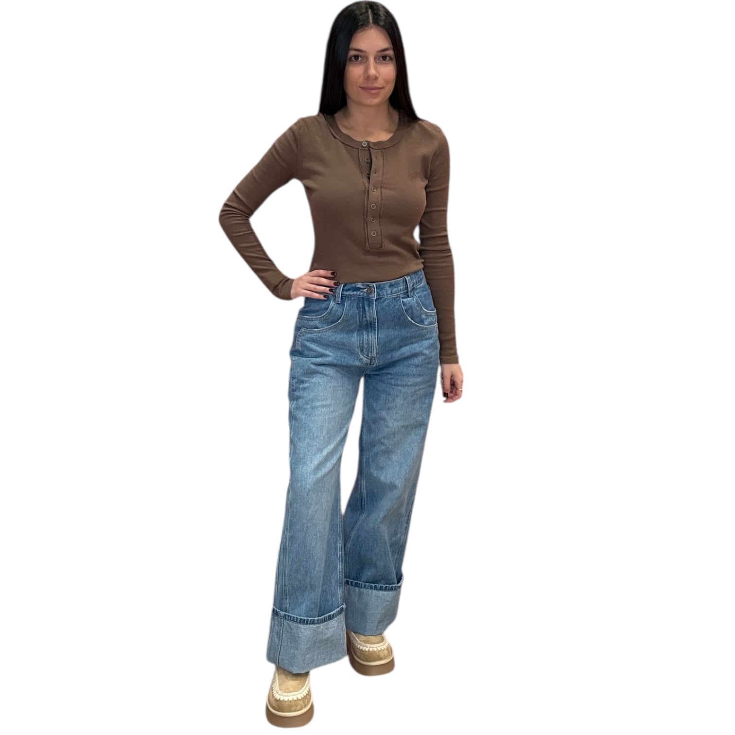 Woman wearing a brown long-sleeve top and blue jeans on a white background