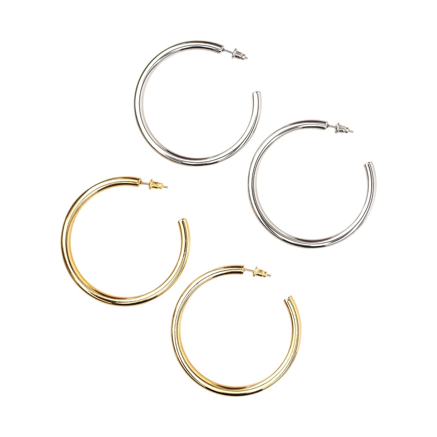 Set of gold and silver hoop earrings on a white background