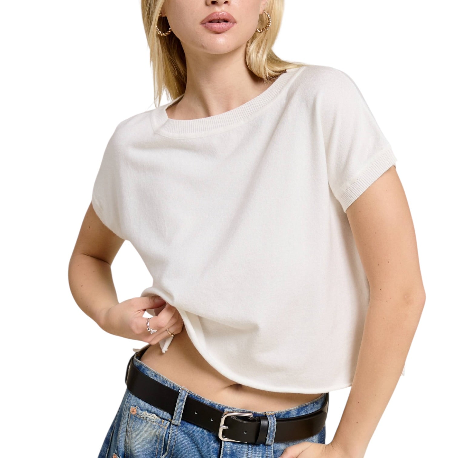 Woman wearing a white t-shirt and blue jeans on a white background