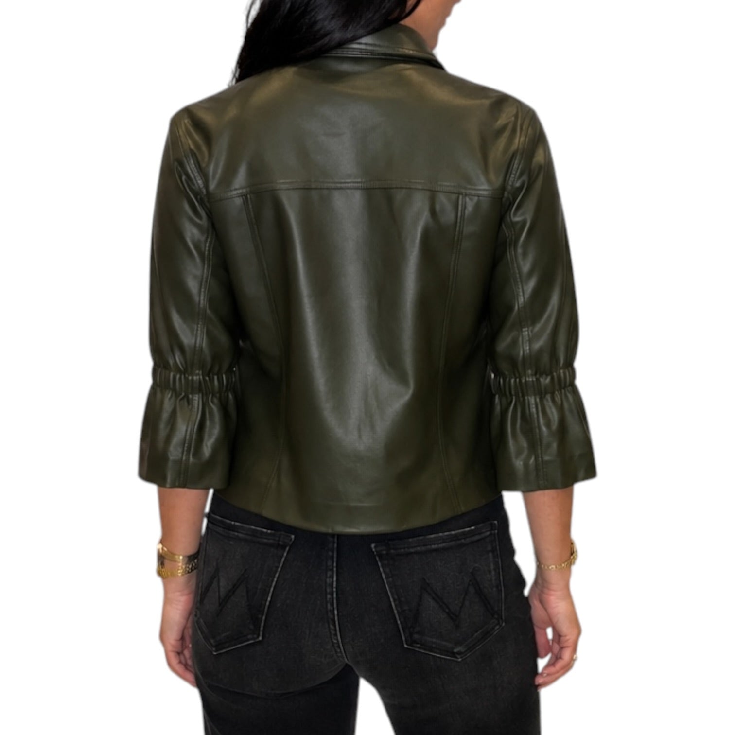 A woman viewed from the back wearing an olive green faux leather jacket with three-quarter ruffled sleeves and black jeans, set against a plain white background.