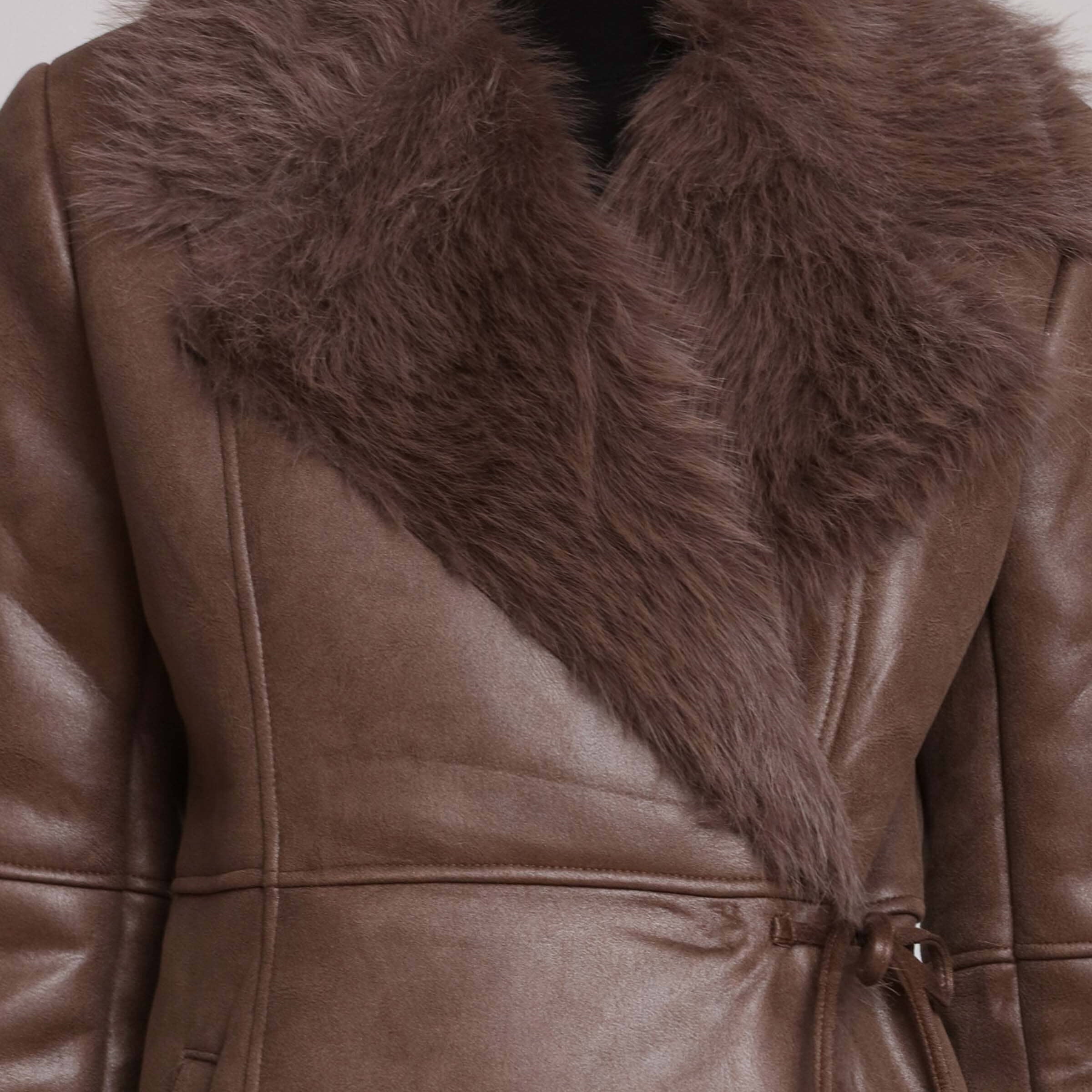 Brown leather coat with fur collar on a neutral background