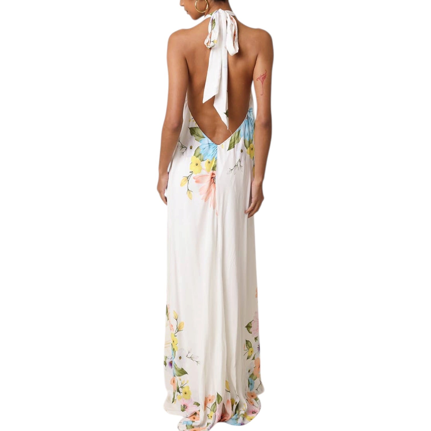 Woman wearing a floral halter neck dress on a white background