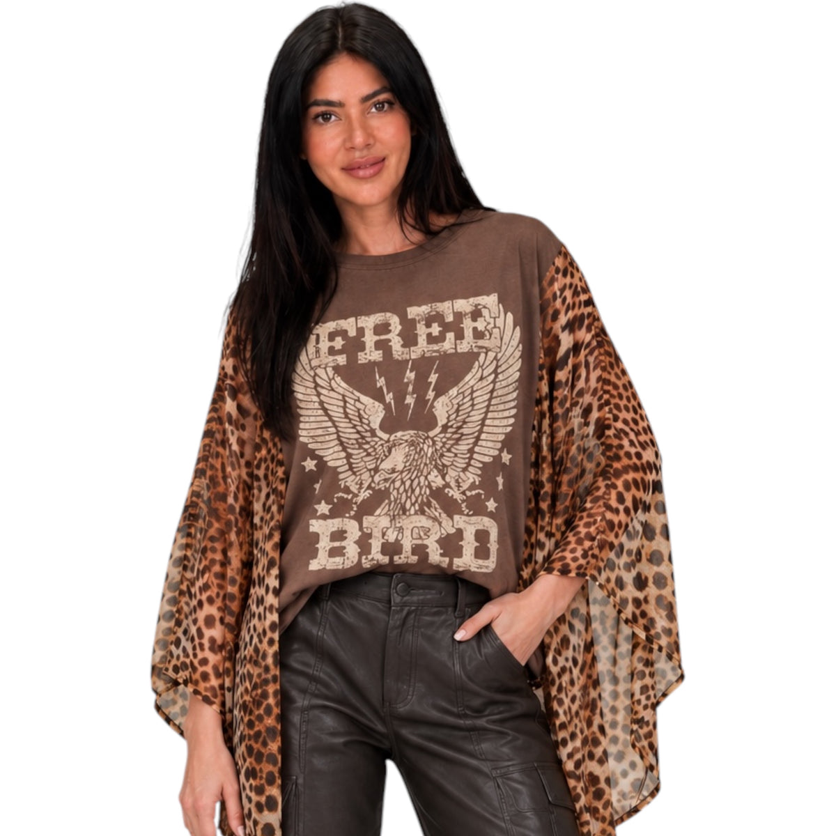 A woman modeling a brown graphic t-shirt with leopard-print sleeves, featuring an eagle design and the words 'FREE BIRD'.