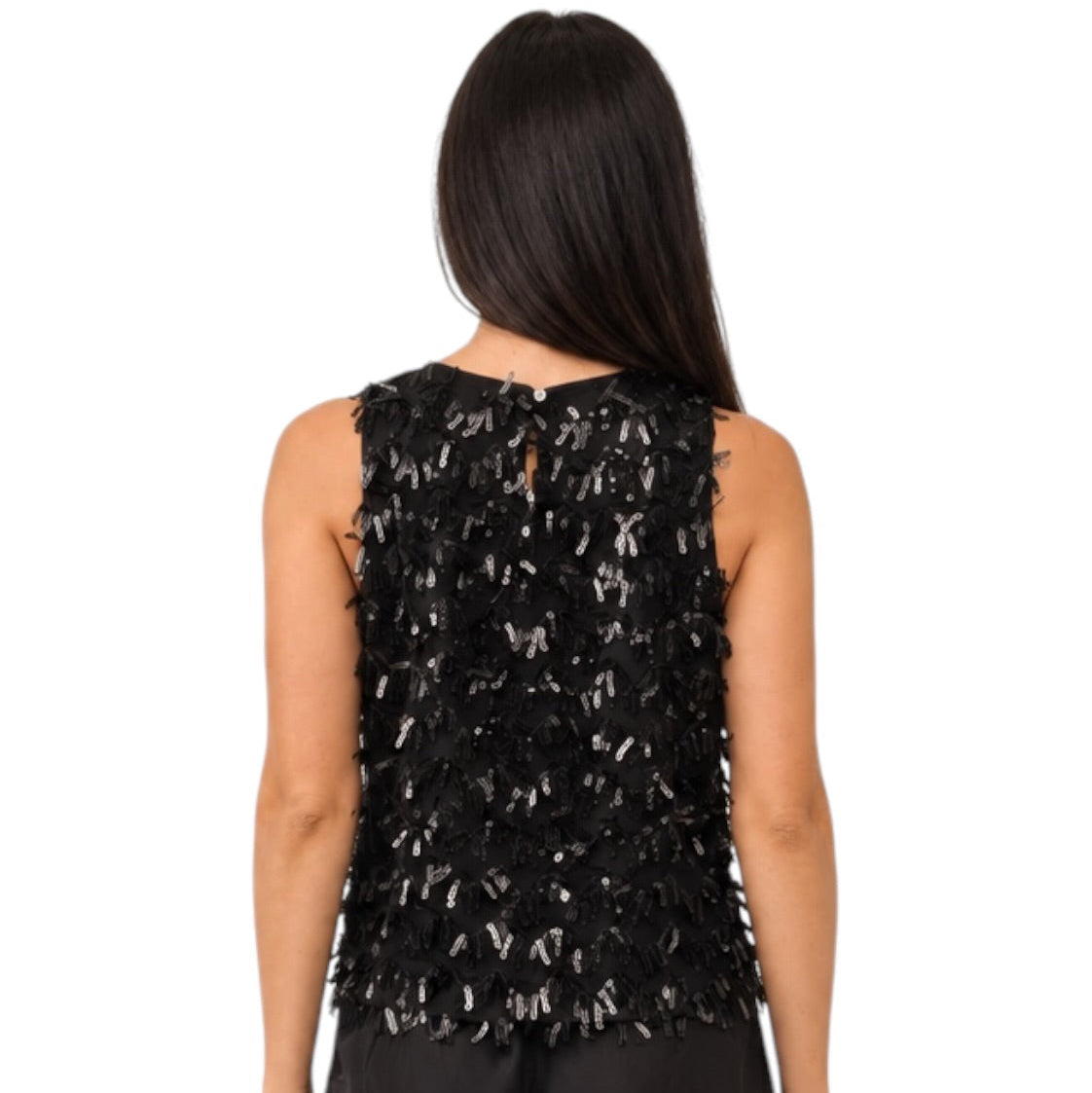 A woman viewed from the back wearing a sleeveless black embellished top with layered feather-like texture and black pants, against a plain white background.