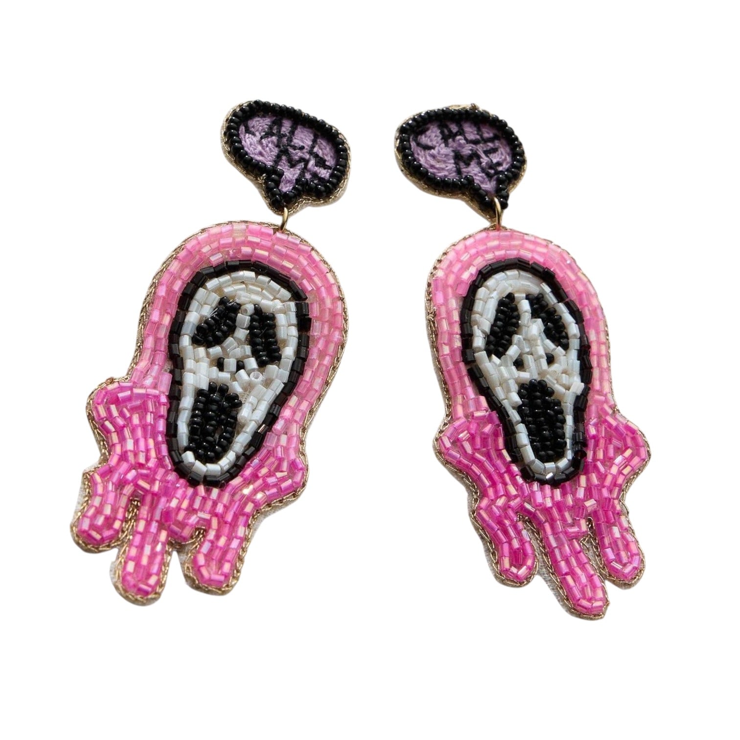 A pair of beaded dangle earrings featuring a pink and white Ghostface design with black and purple eyes, outlined in gold-tone metal on a white background.
