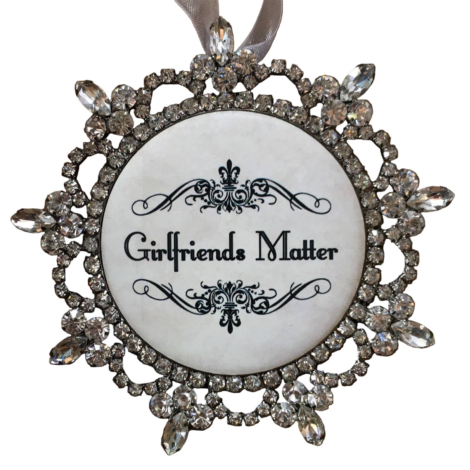 Decorative ornament with 'Girlfriends Matter' text and crystal embellishments on a white background