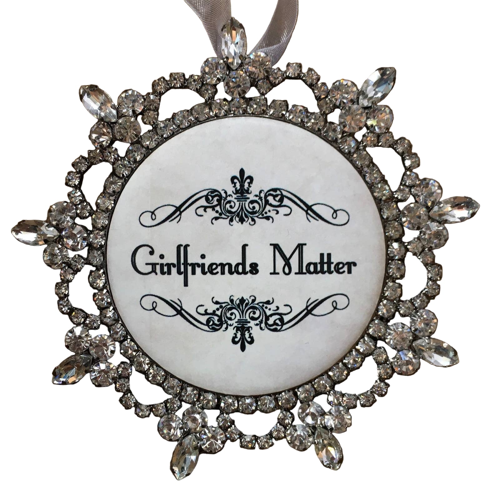 Decorative ornament with 'Girlfriends Matter' text and crystal embellishments on a white background