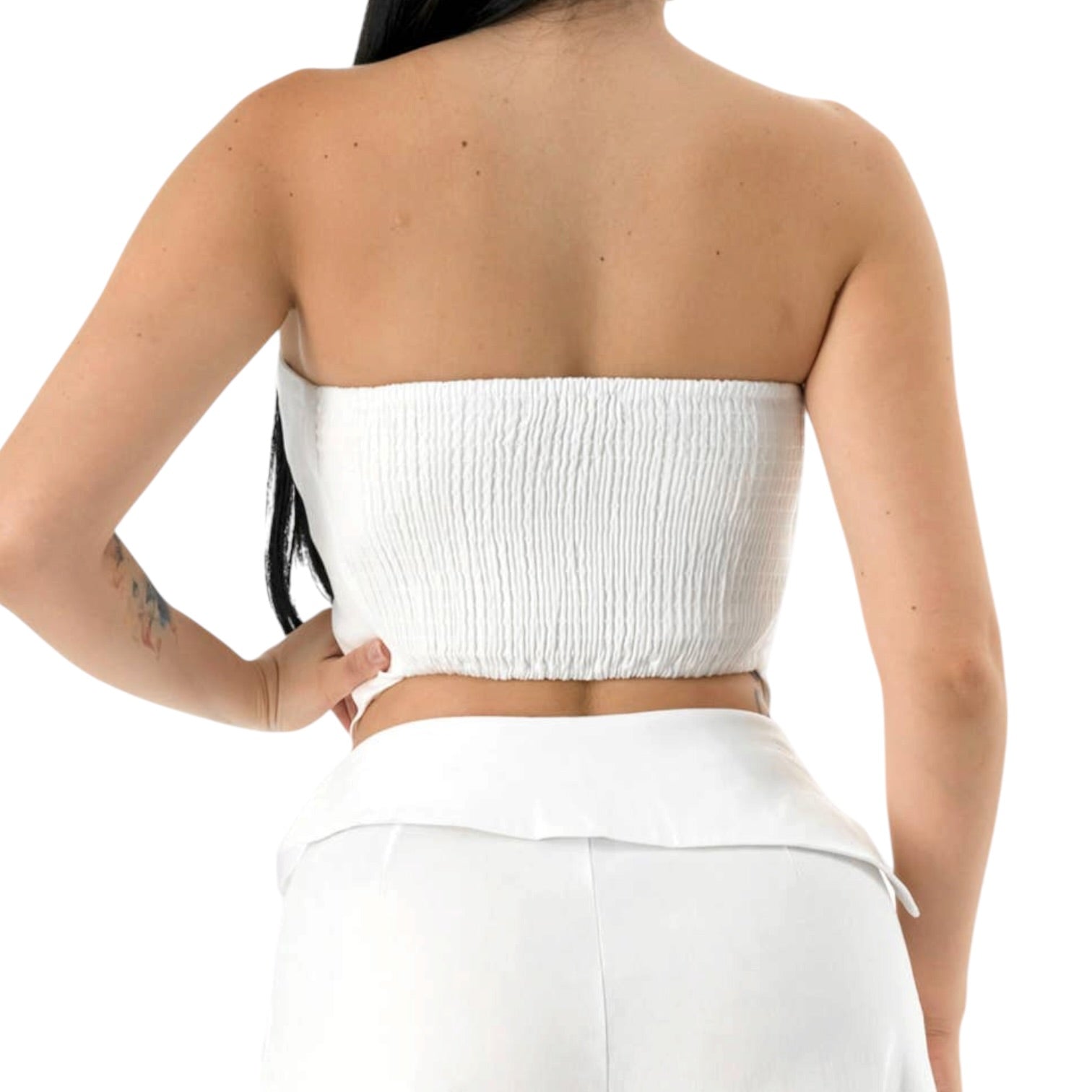 White strapless top worn by a person on a white background