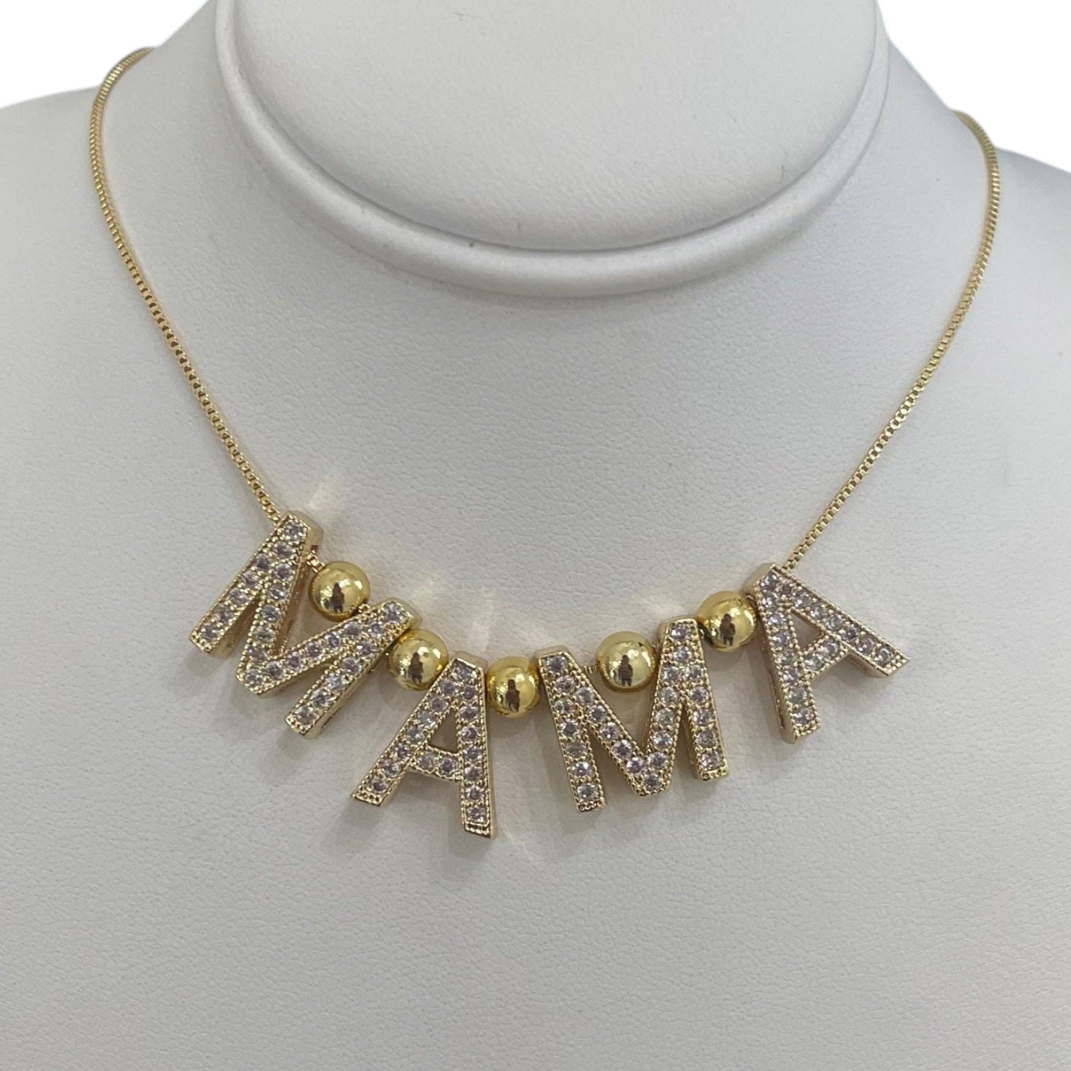 Necklace with 'MAMA' letters on a mannequin bust