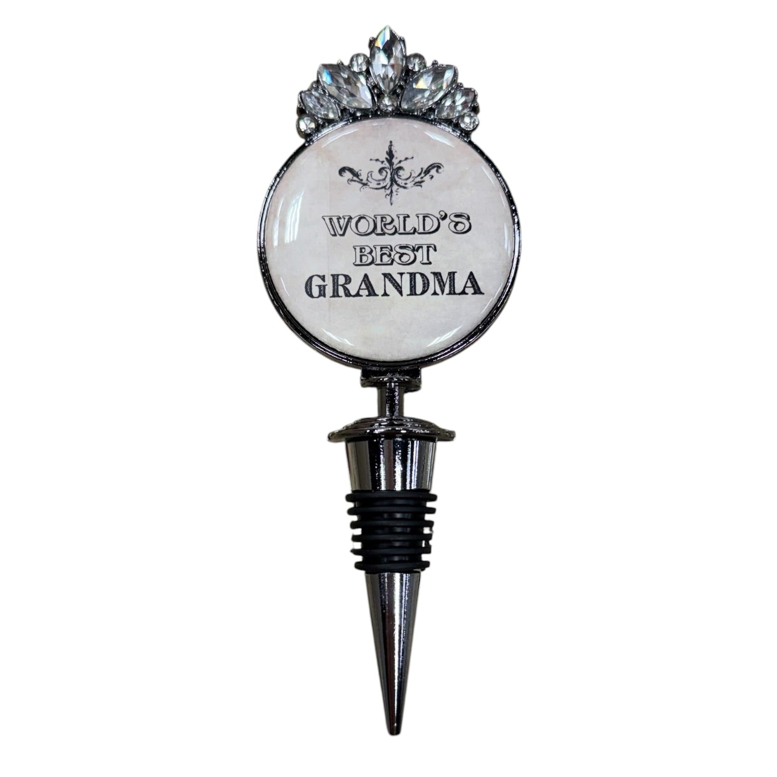 A novelty wine bottle stopper designed as a round medallion with the text 'WORLD'S BEST GRANDMA' in black lettering on a white background, topped with a silver rhinestone crown, and fitted with a black and silver threaded stopper base.