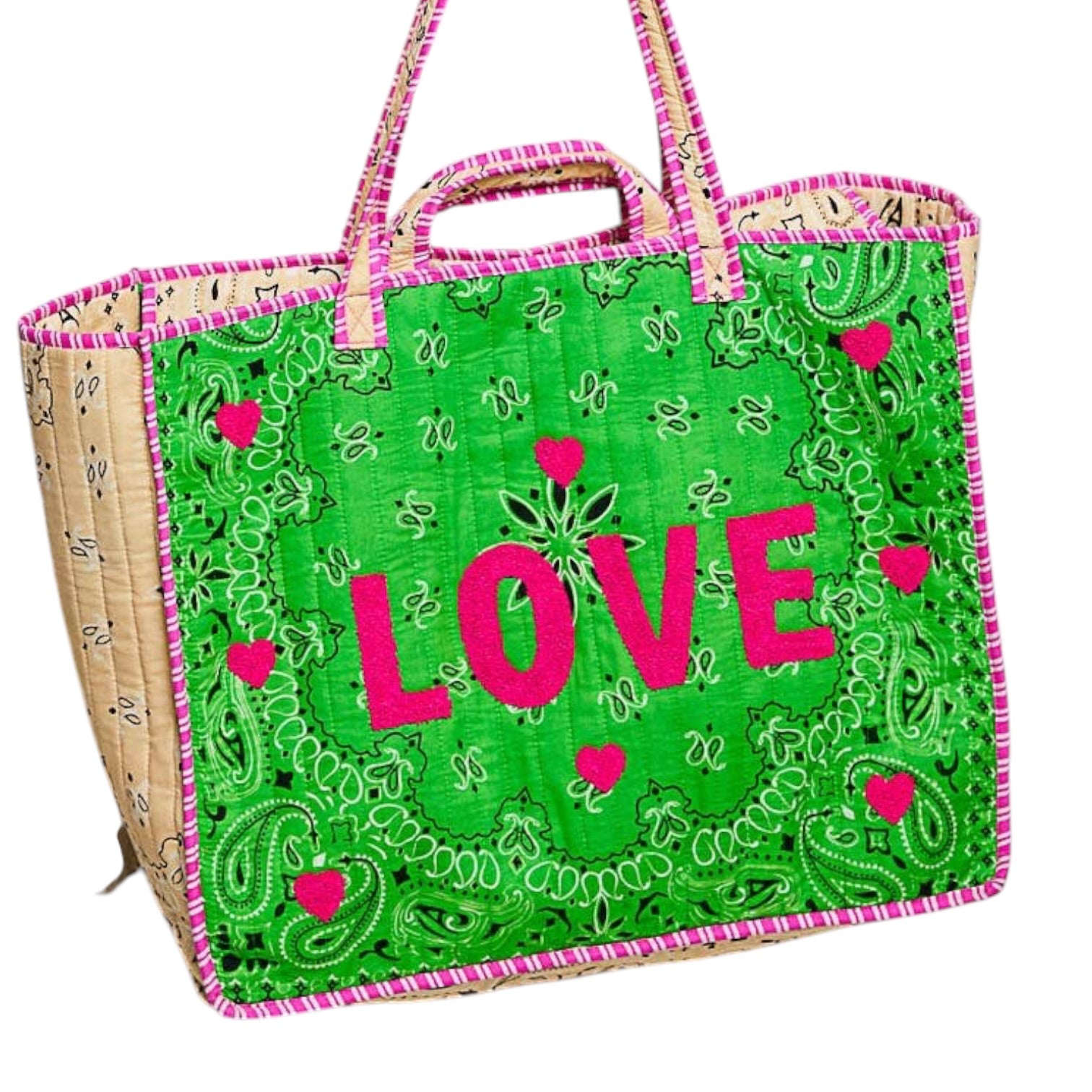 A woven tote bag with a bright green front panel featuring a paisley bandana pattern, pink embroidered hearts, and the word 'LOVE' in large pink letters. The sides of the bag are natural beige woven material, and it has pink and green striped handles.