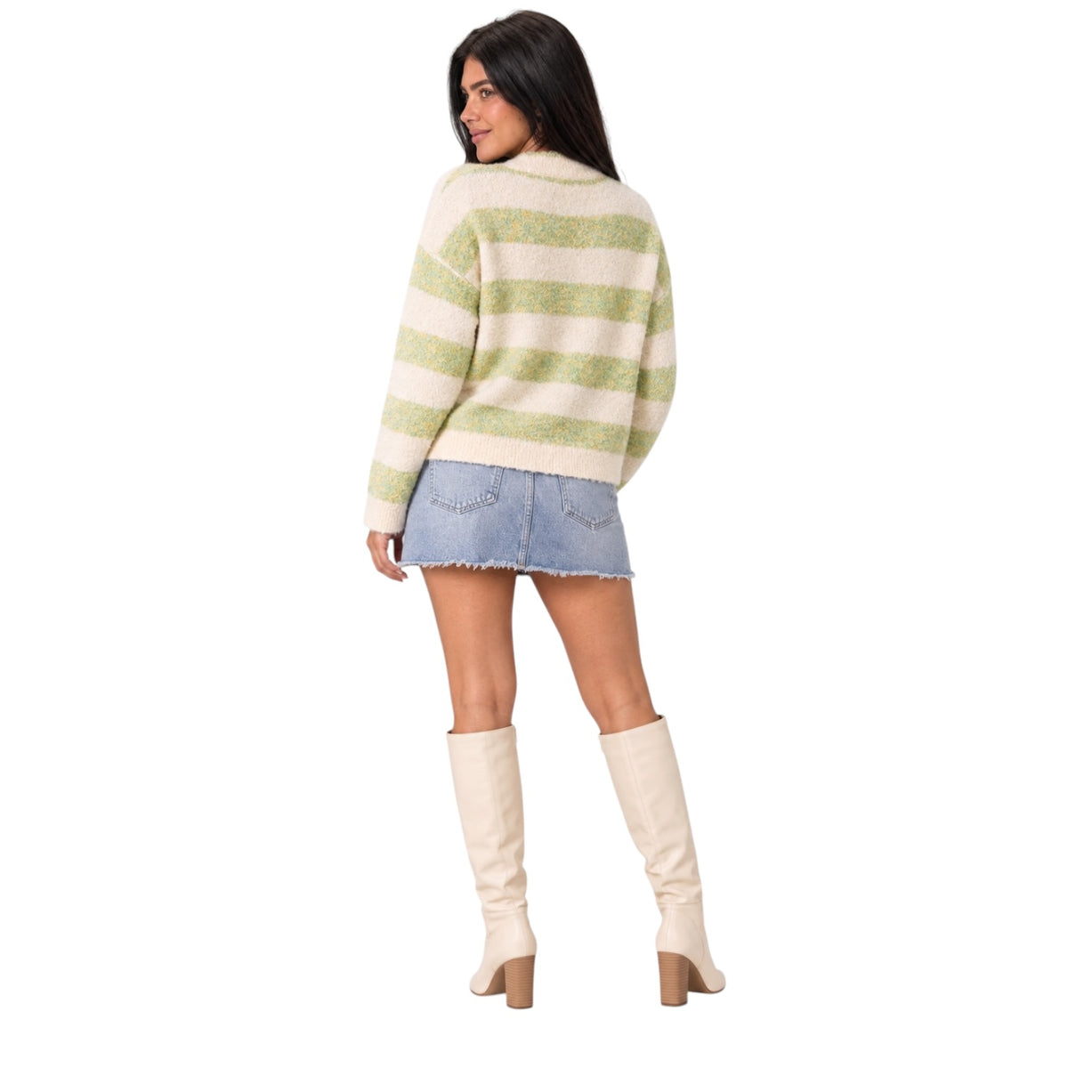 A woman shown from the back wearing a cream and light green striped fuzzy knit sweater, a denim mini skirt, and cream knee-high heeled boots against a plain white background.