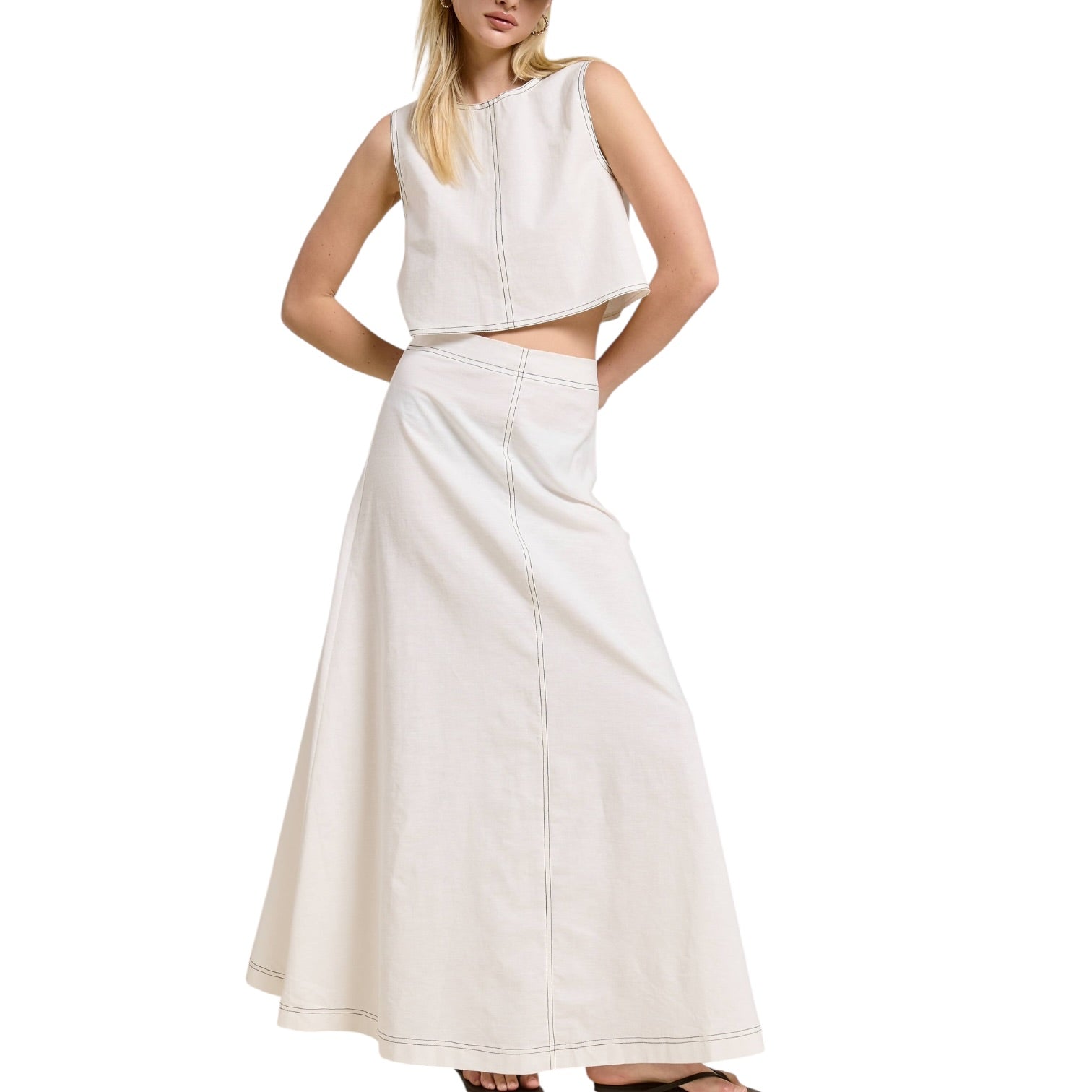 Woman wearing a white sleeveless top and skirt set on a white background