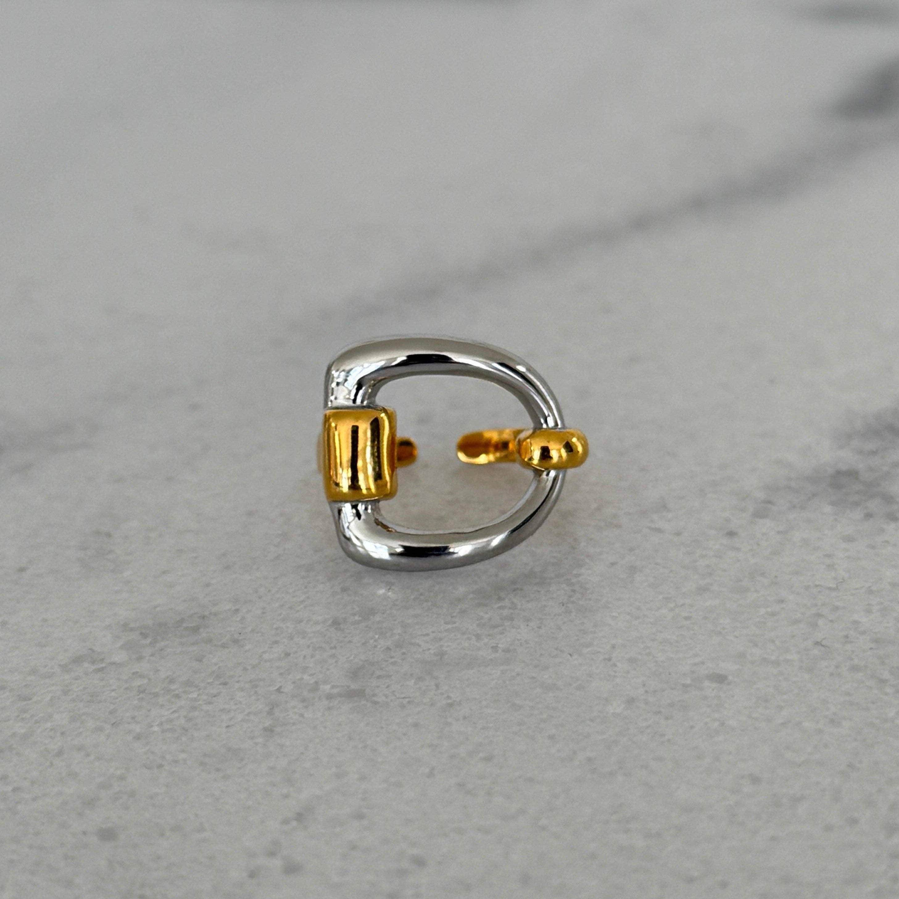 gold & silver ring on grey surface