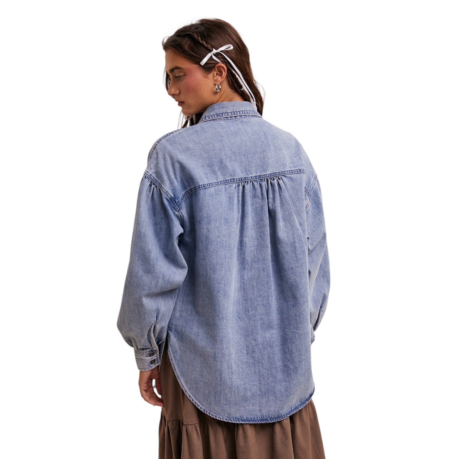 Person wearing a blue denim shirt on a white background