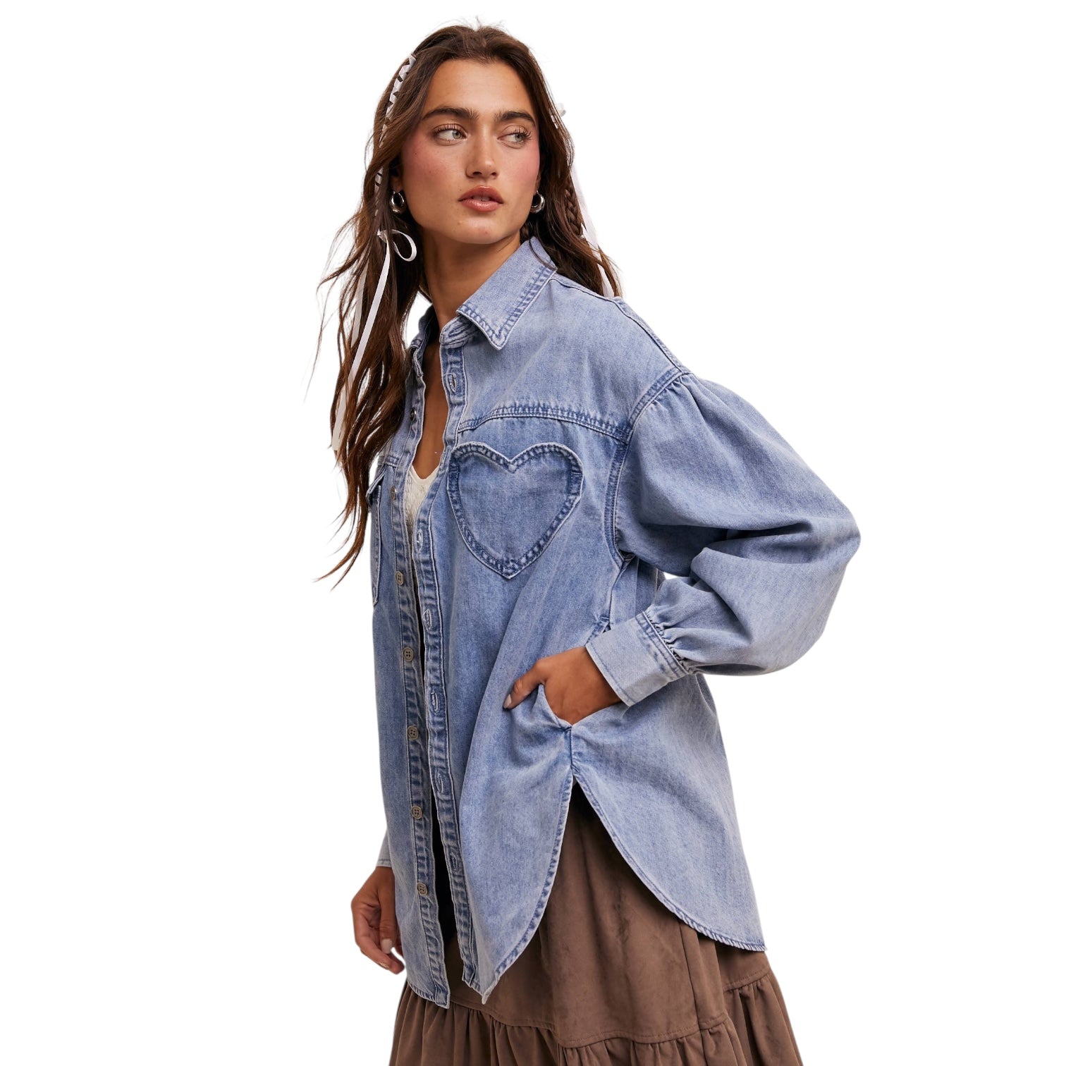 Woman wearing a light blue denim shirt on a white background