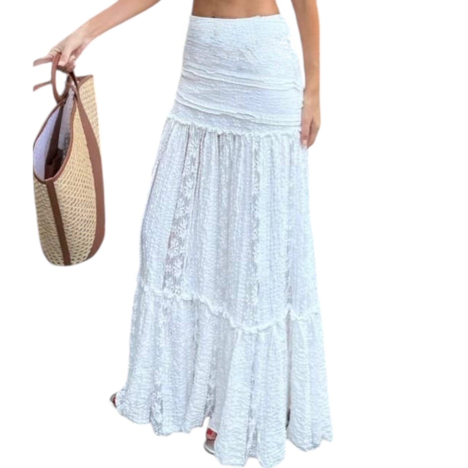 Woman wearing a light blue lace maxi skirt holding a straw bag on a white background