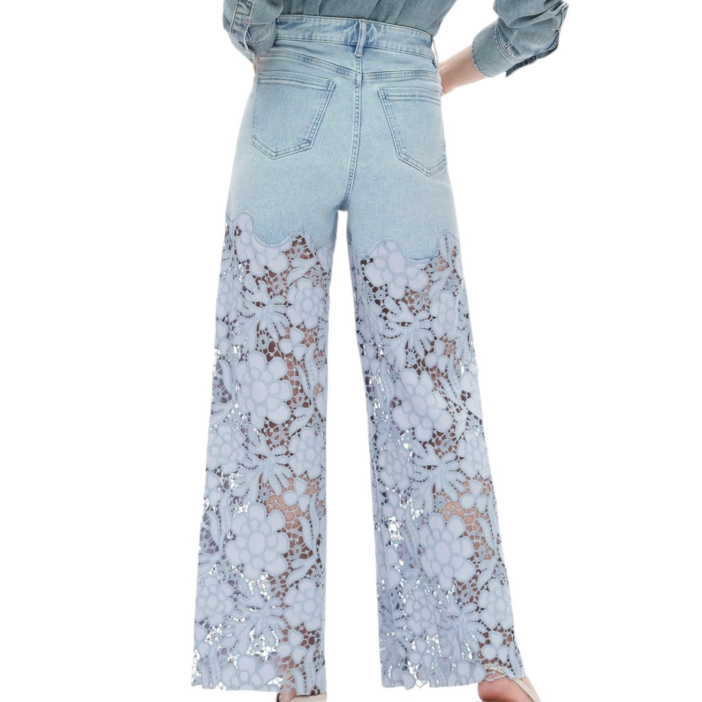 Light blue jeans with floral lace detailing on a white background