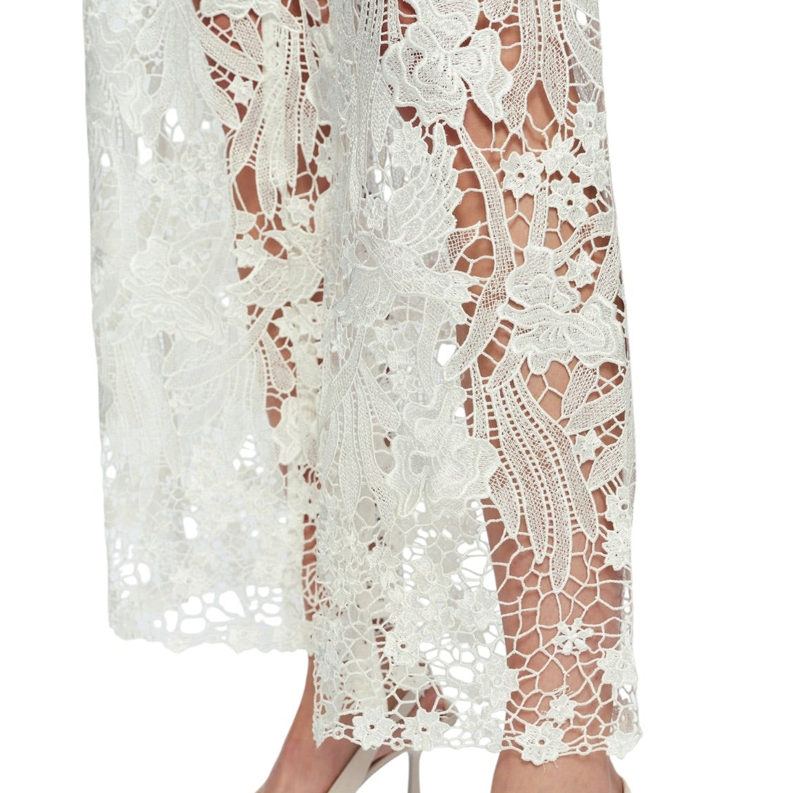 White lace dress with beige high-heeled shoes on a white background