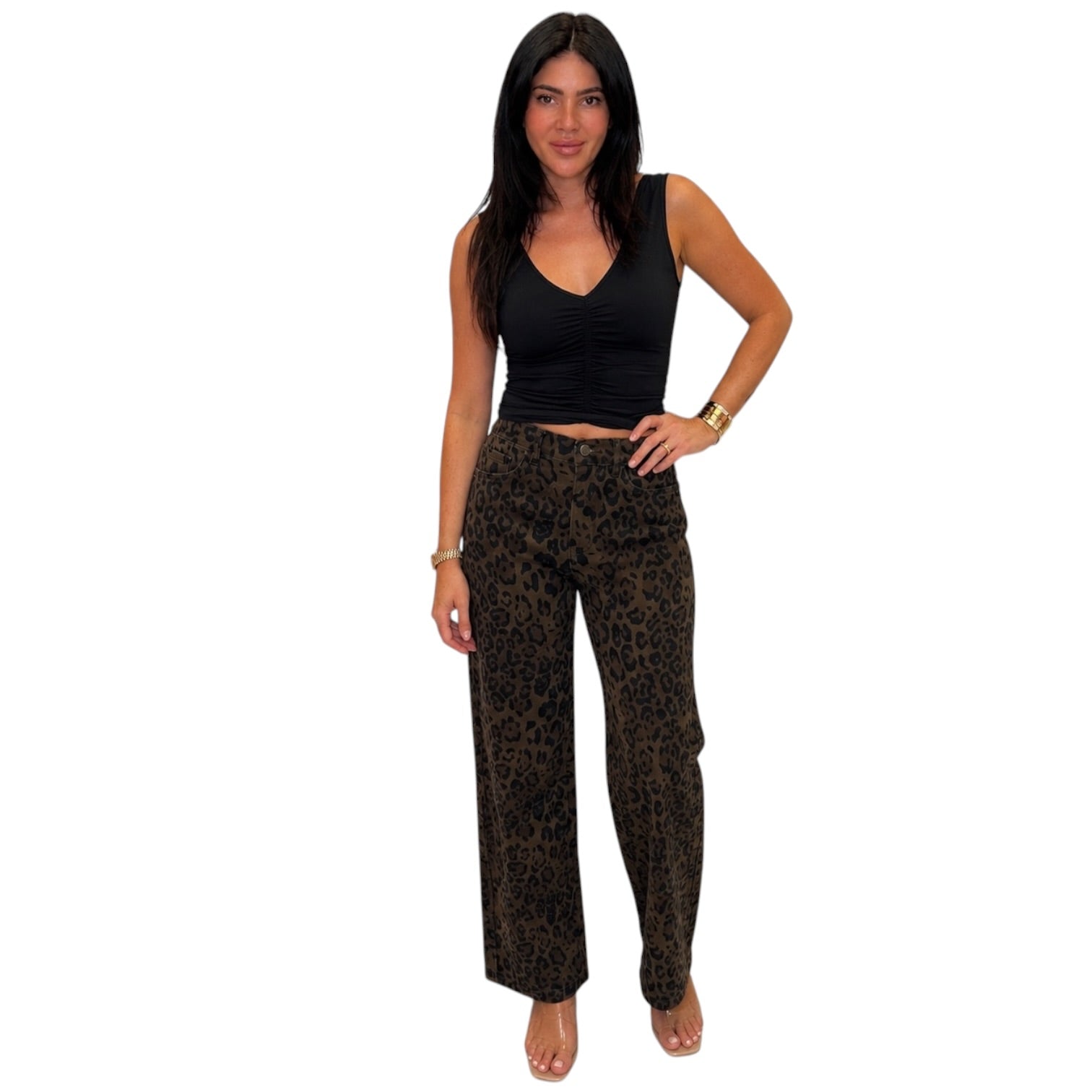 A woman modeling a black sleeveless crop top and brown leopard-print wide-leg pants against a plain white background.