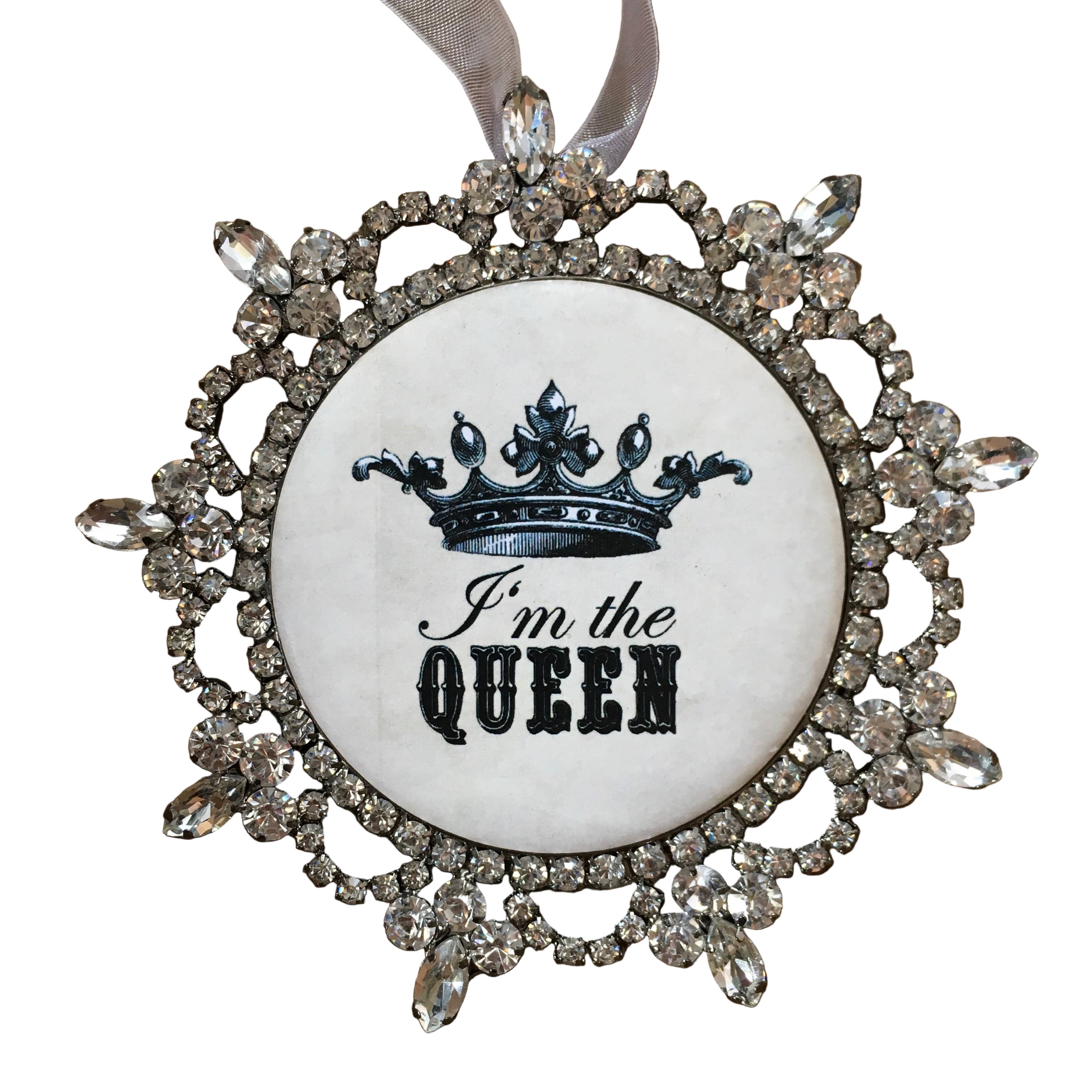 Decorative ornament with a crown and 'I'm the Queen' text on a wooden background