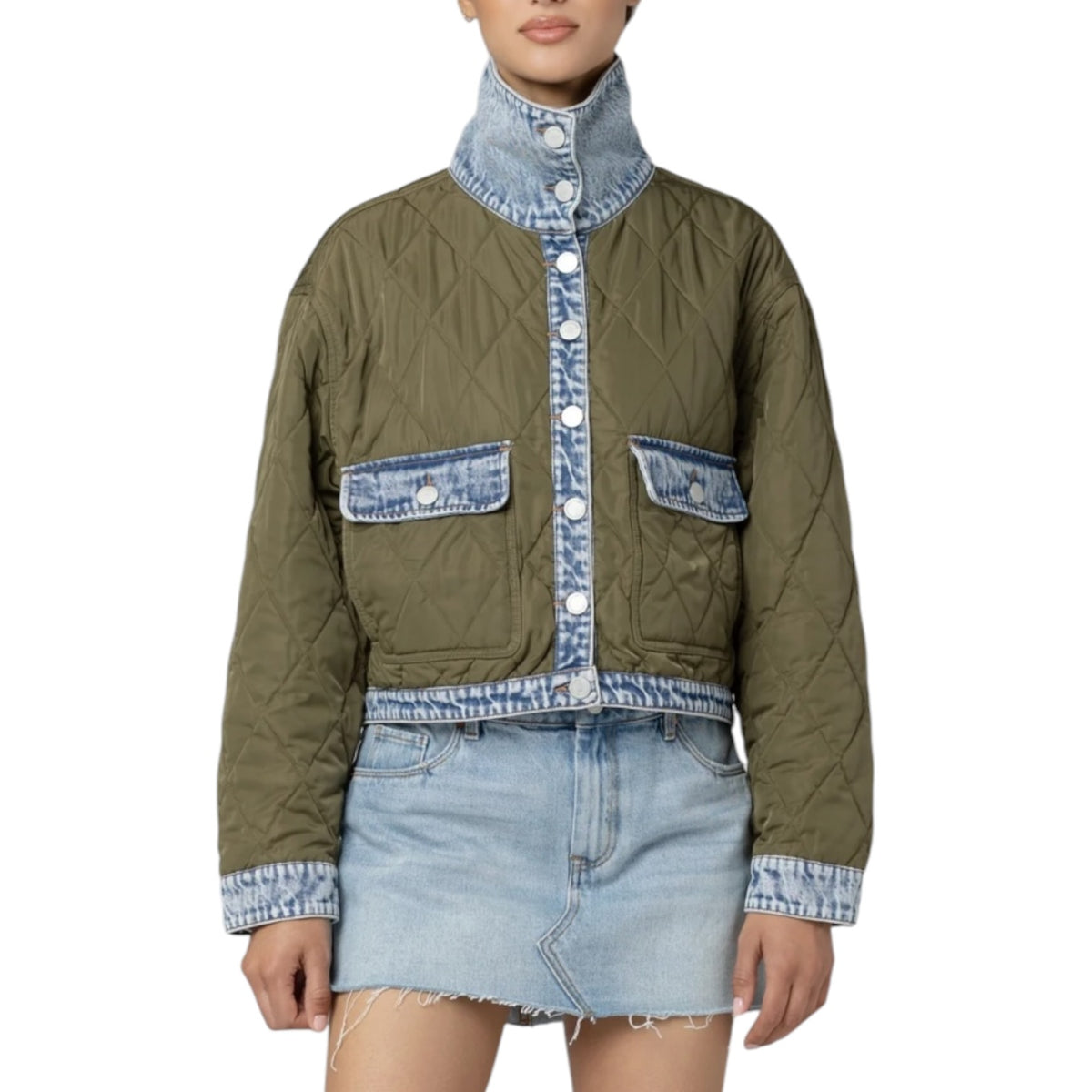 A model wearing a quilted olive green jacket with light blue denim trim, featuring a high stand-up collar, button-front placket, and two flap pockets on a white background.